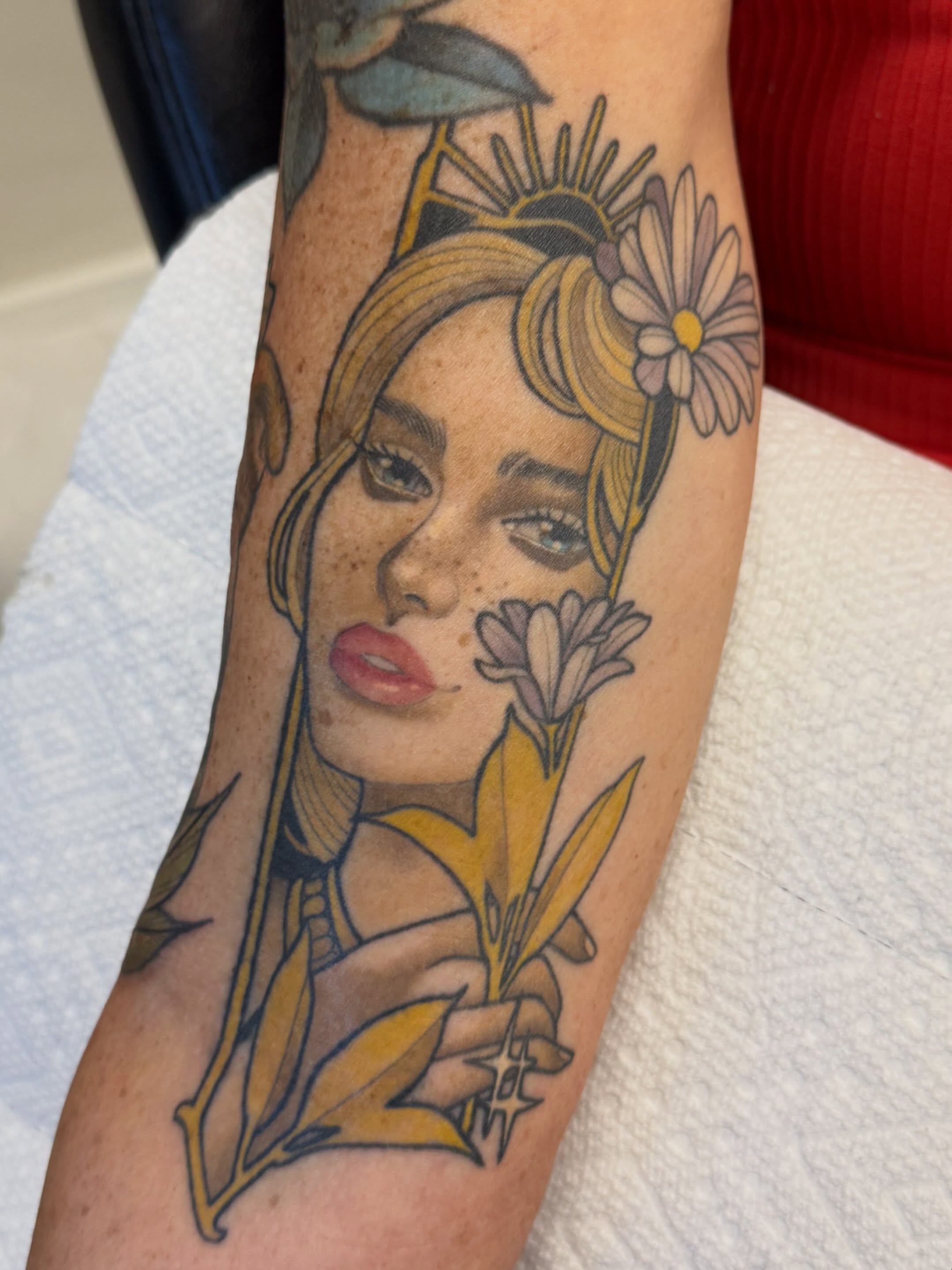 Woman with flowers realism tattoo on the forearm by Connie Fiorino - Tattoo Artist