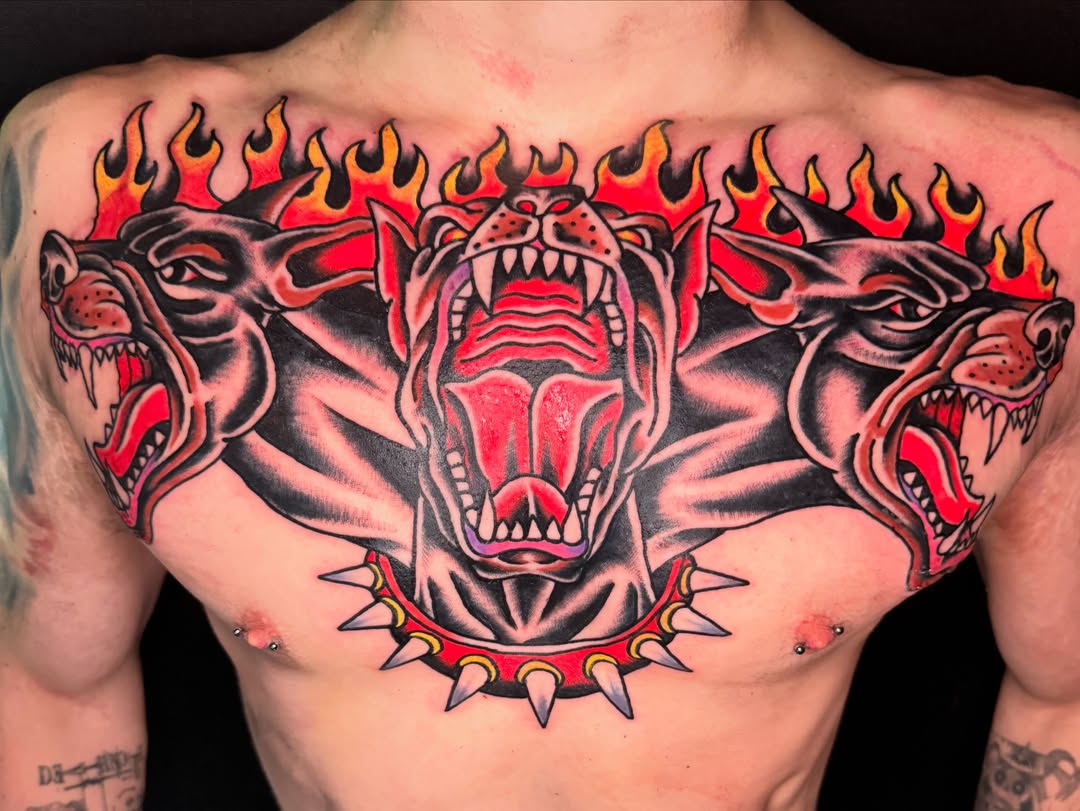 Roaring dogs American traditional tattoo on the chest by Kenny Kastro