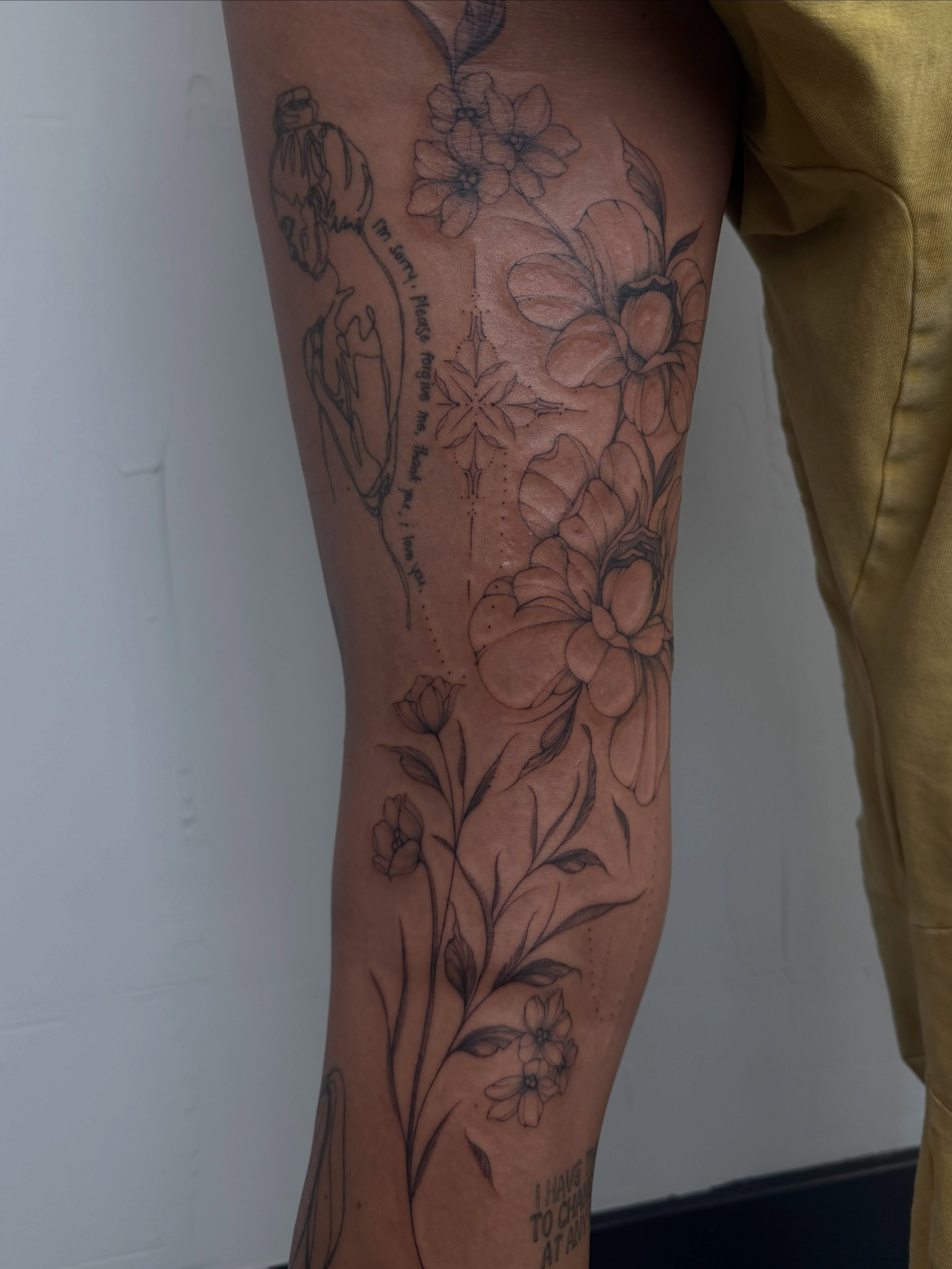 Floral arrangement realism tattoo on the calf by Hannah Matthews
