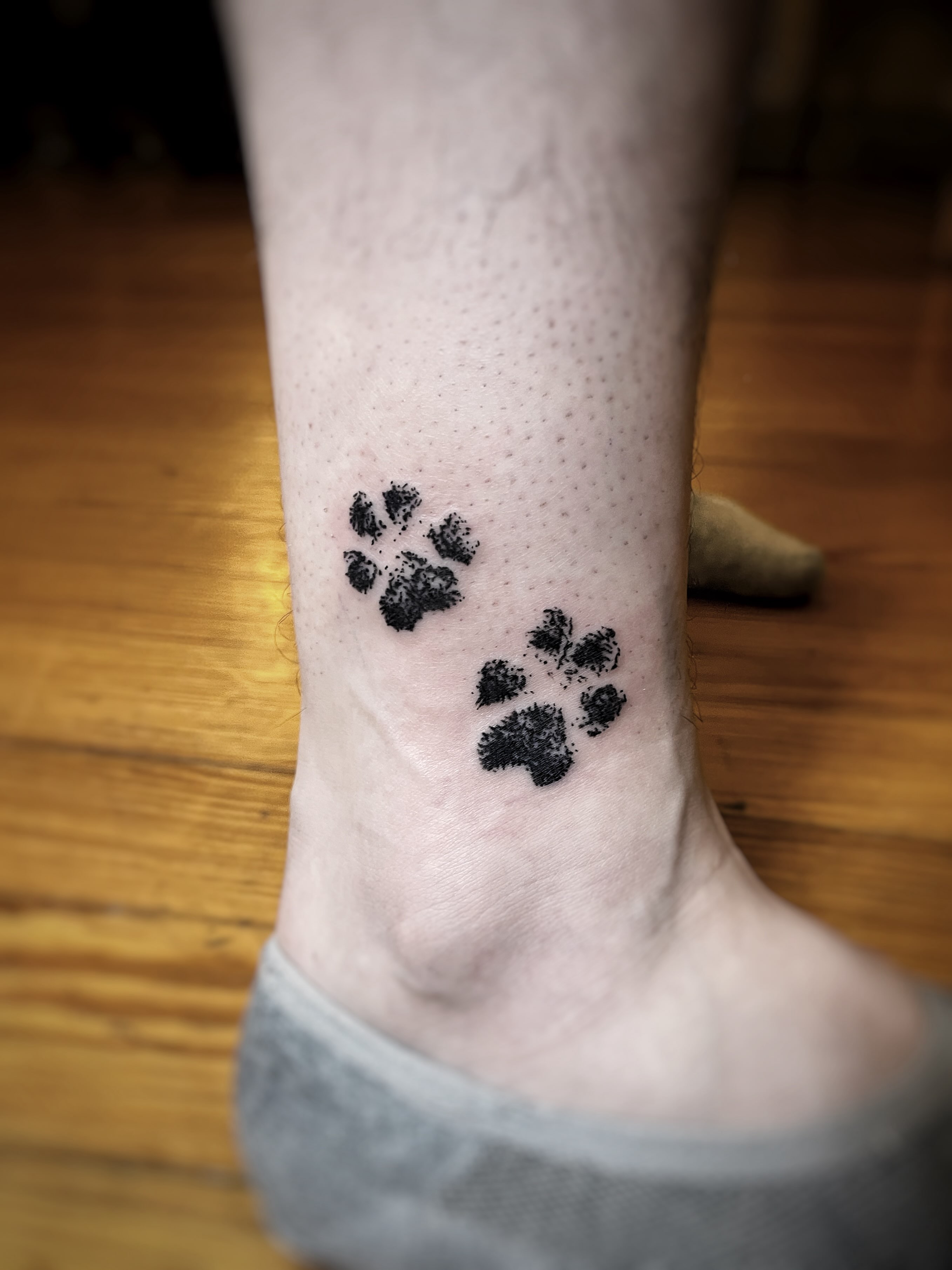 Paw prints dotwork tattoo on the foot by Risa Cincinnati Tattoo Artist