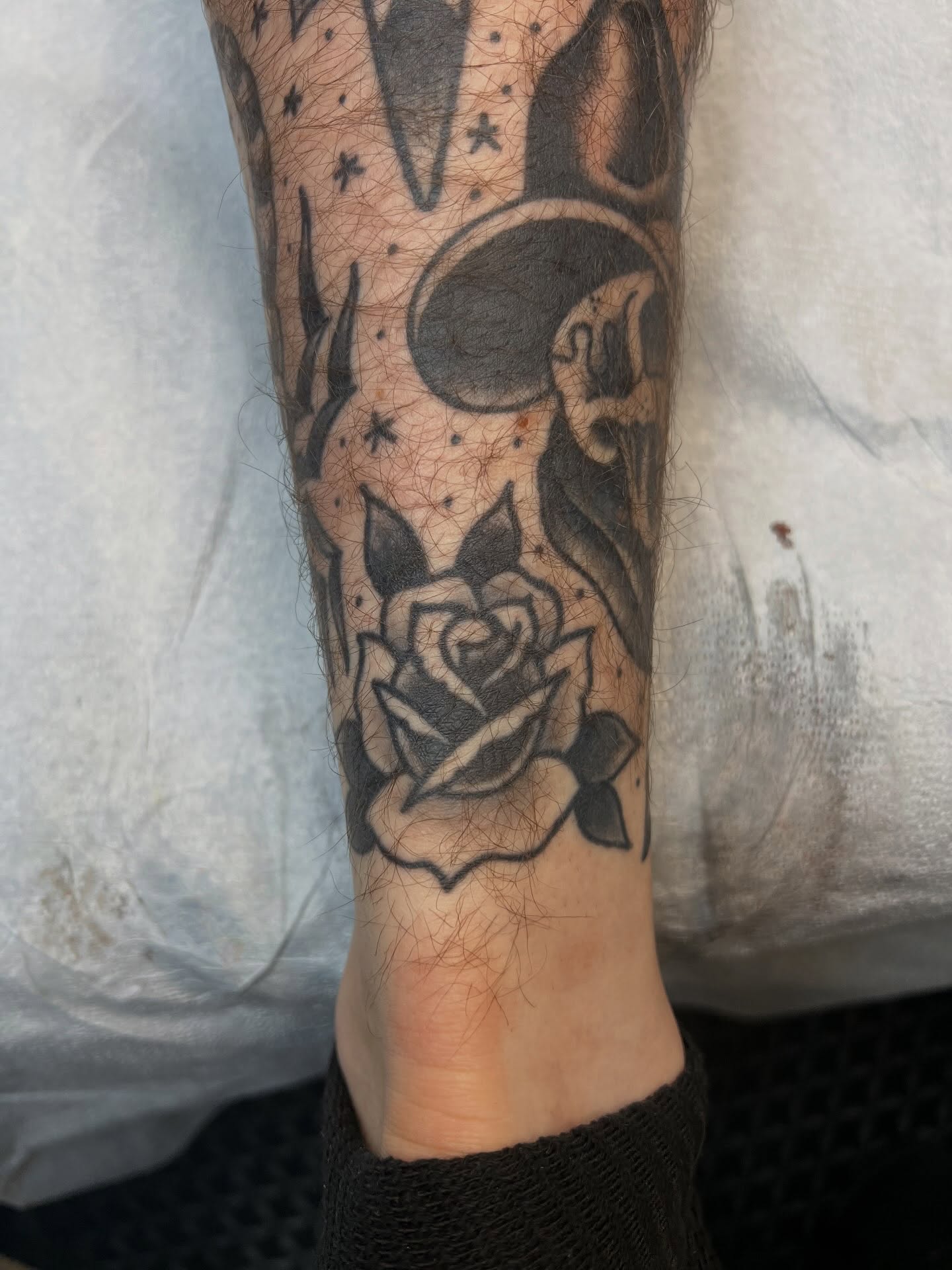Rose and moon black and grey tattoo on the forearm by Tyler Van Pelt