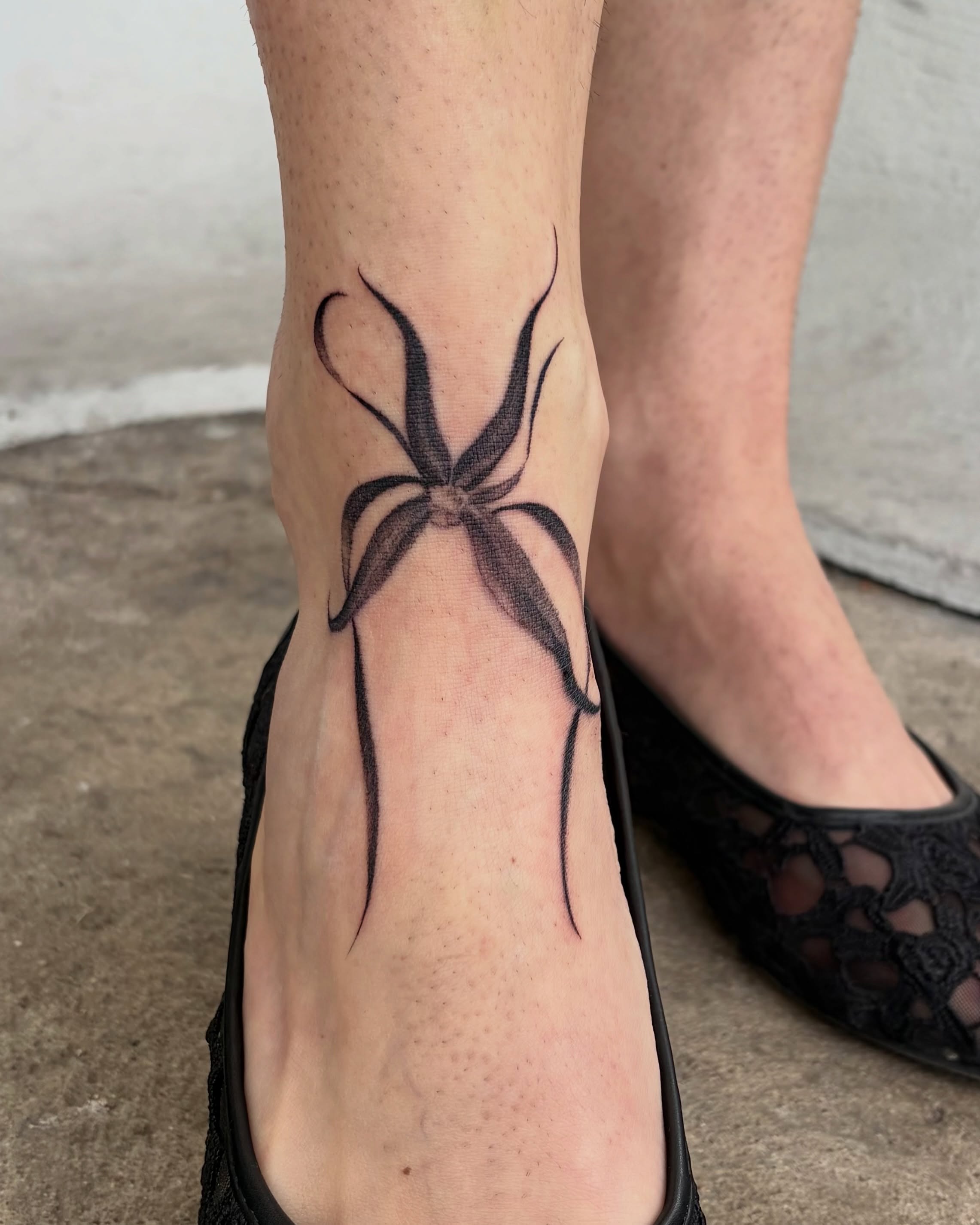 Spider black and grey tattoo on the foot by Kylah Amin Tattoo