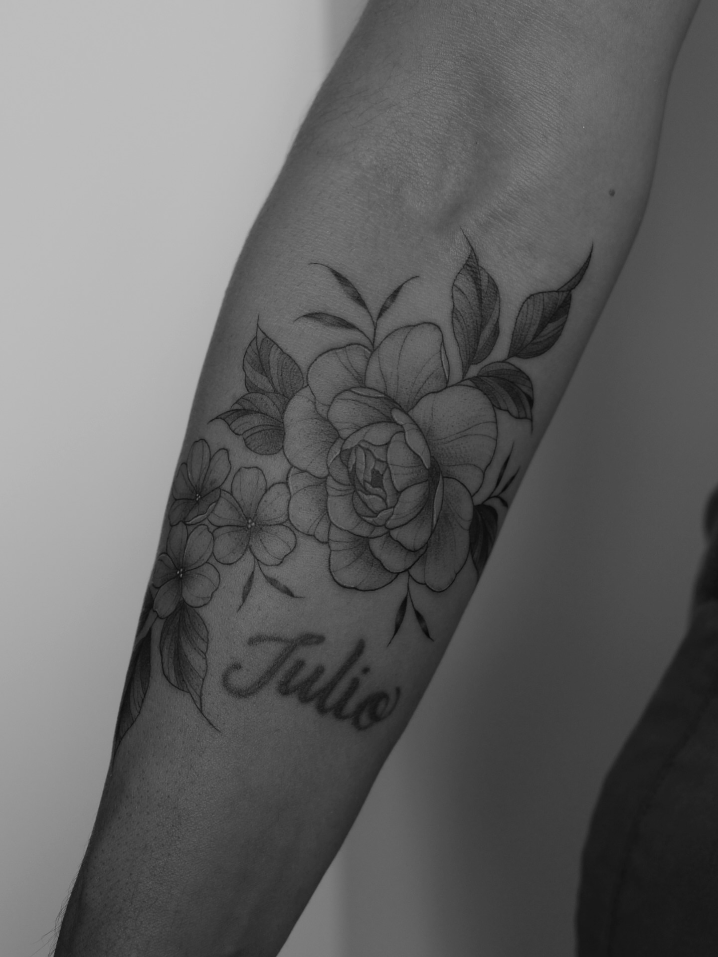 Floral arrangement realism tattoo on the forearm by Haley Sayers