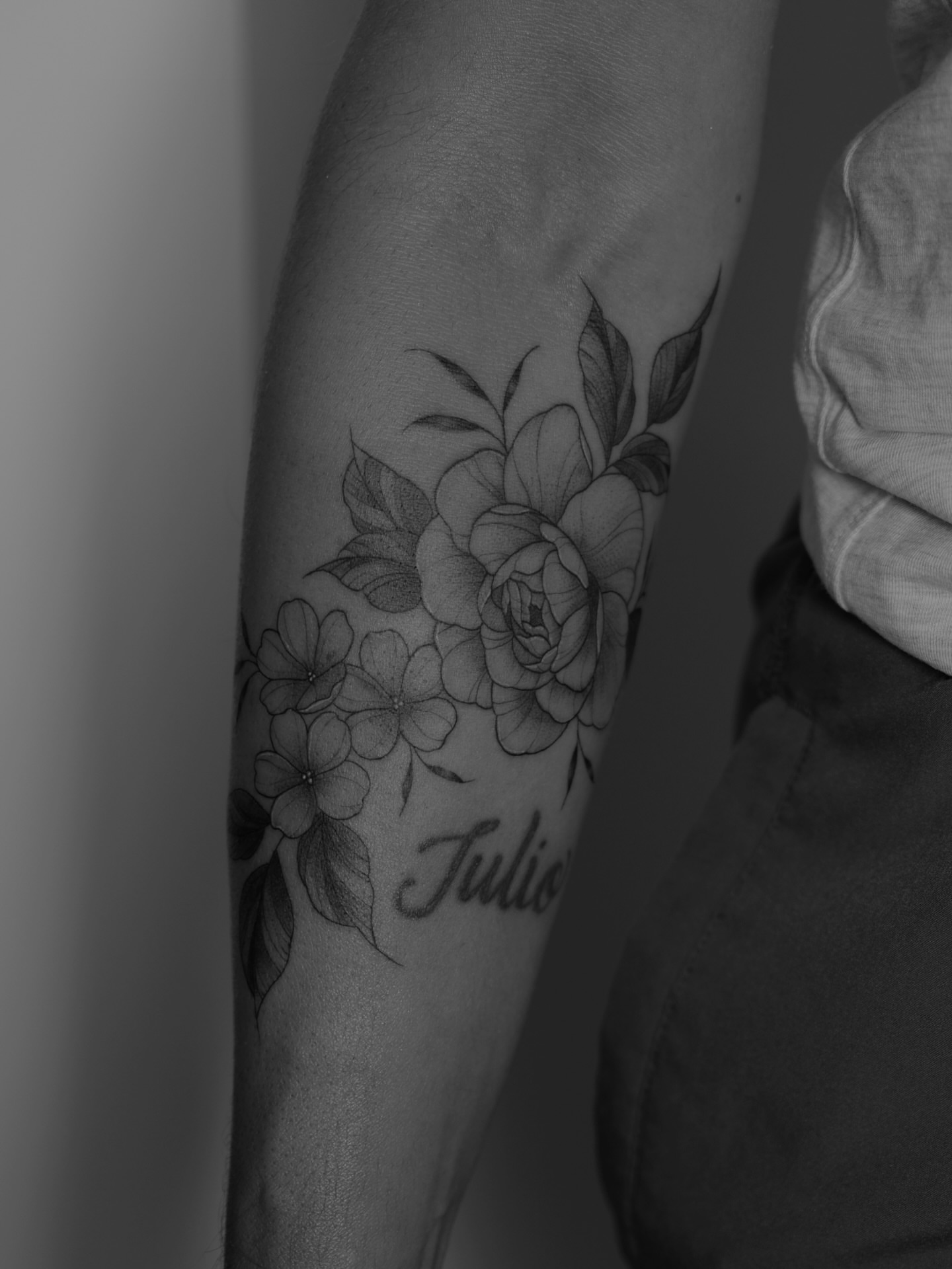 Floral bouquet black and grey tattoo on the forearm by Haley Sayers