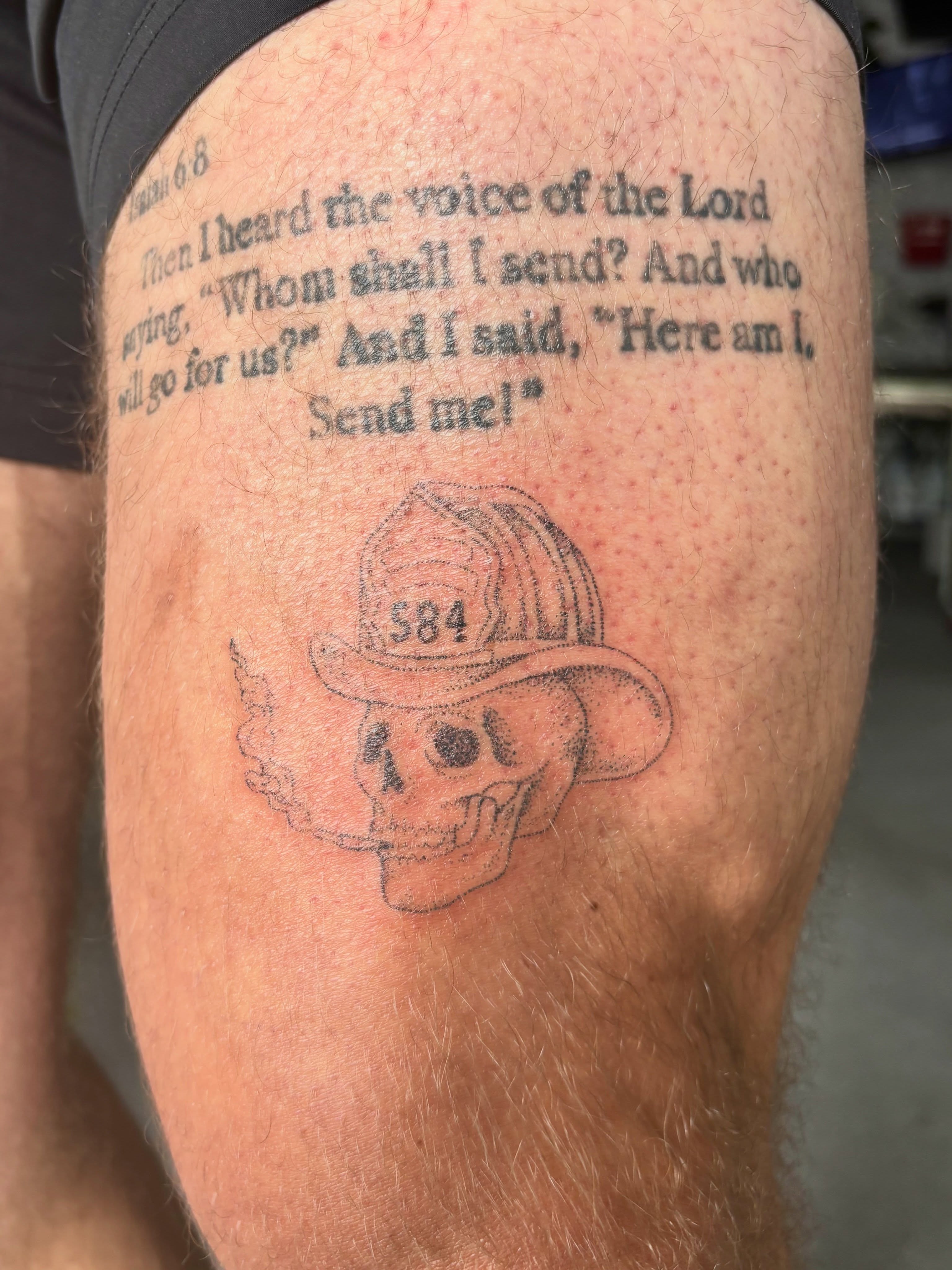 Firefighter helmet and skull black and grey tattoo on the thigh by Ashley, Elk Horn, Iowa