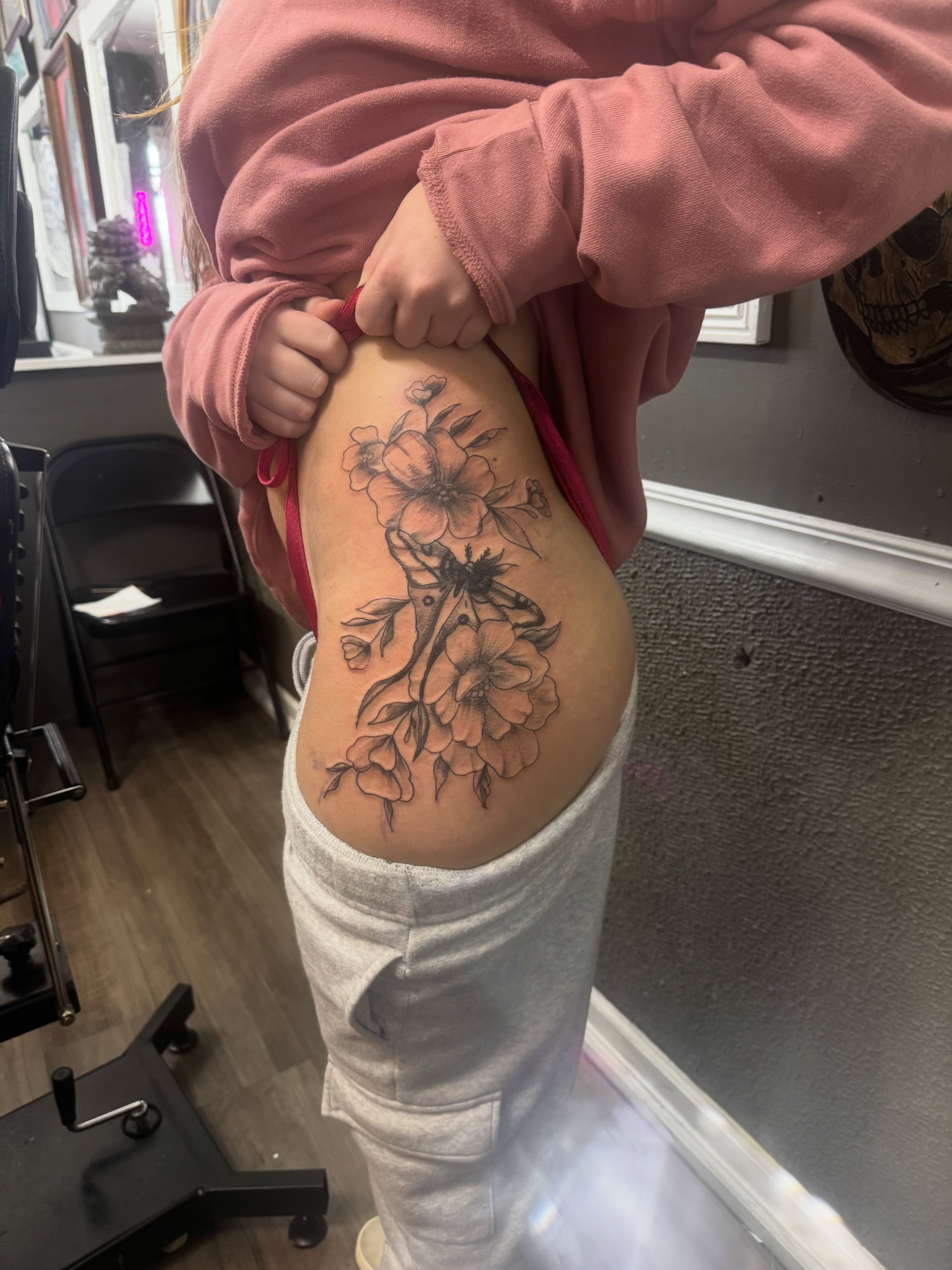 Floral design black and grey tattoo on the thigh by Lexy