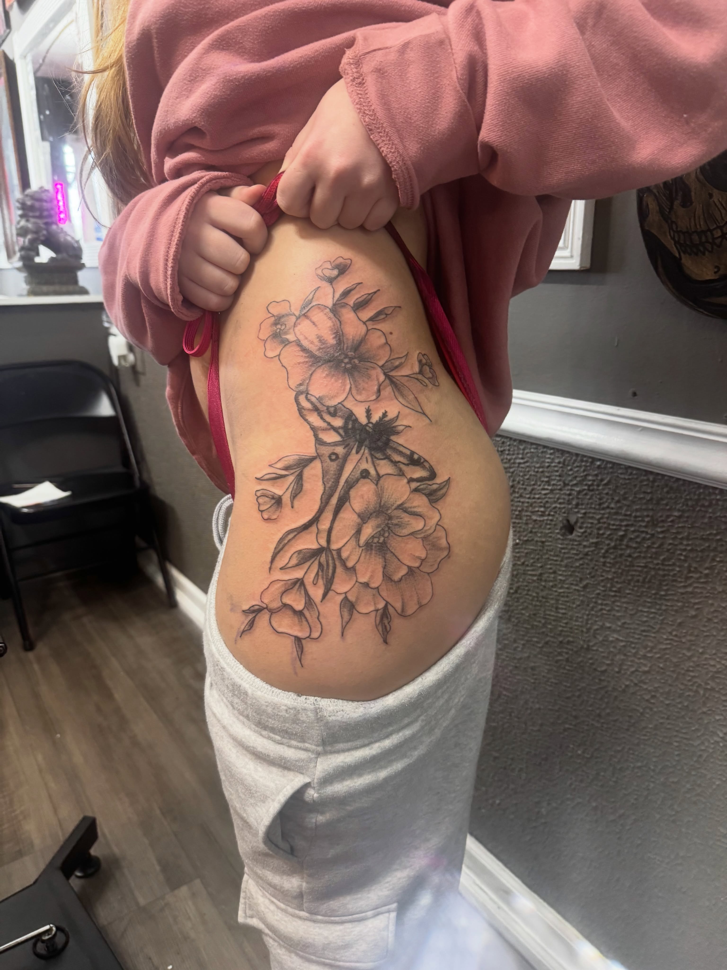 Floral arrangement black and grey tattoo on the thigh by Lexy