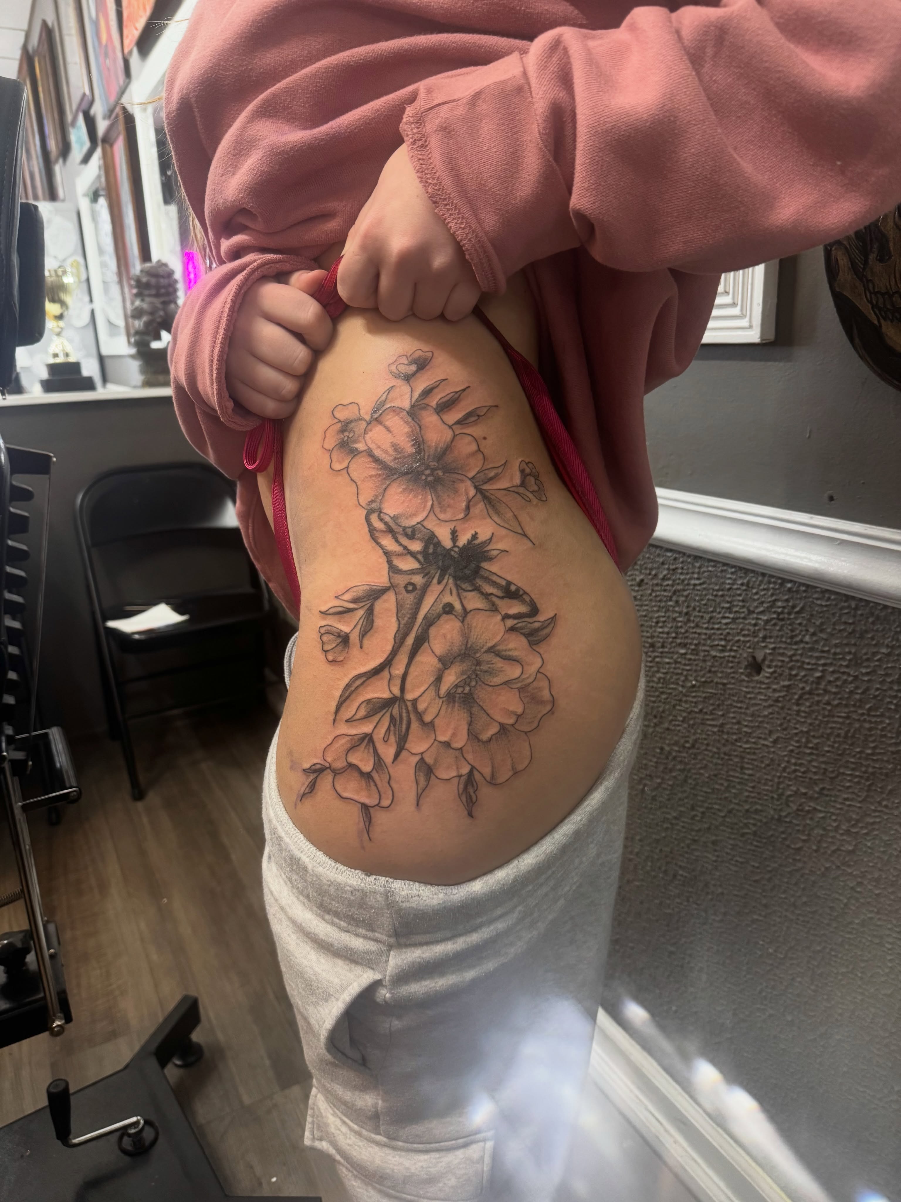 Floral arrangement black and grey tattoo on the thigh by Lexy