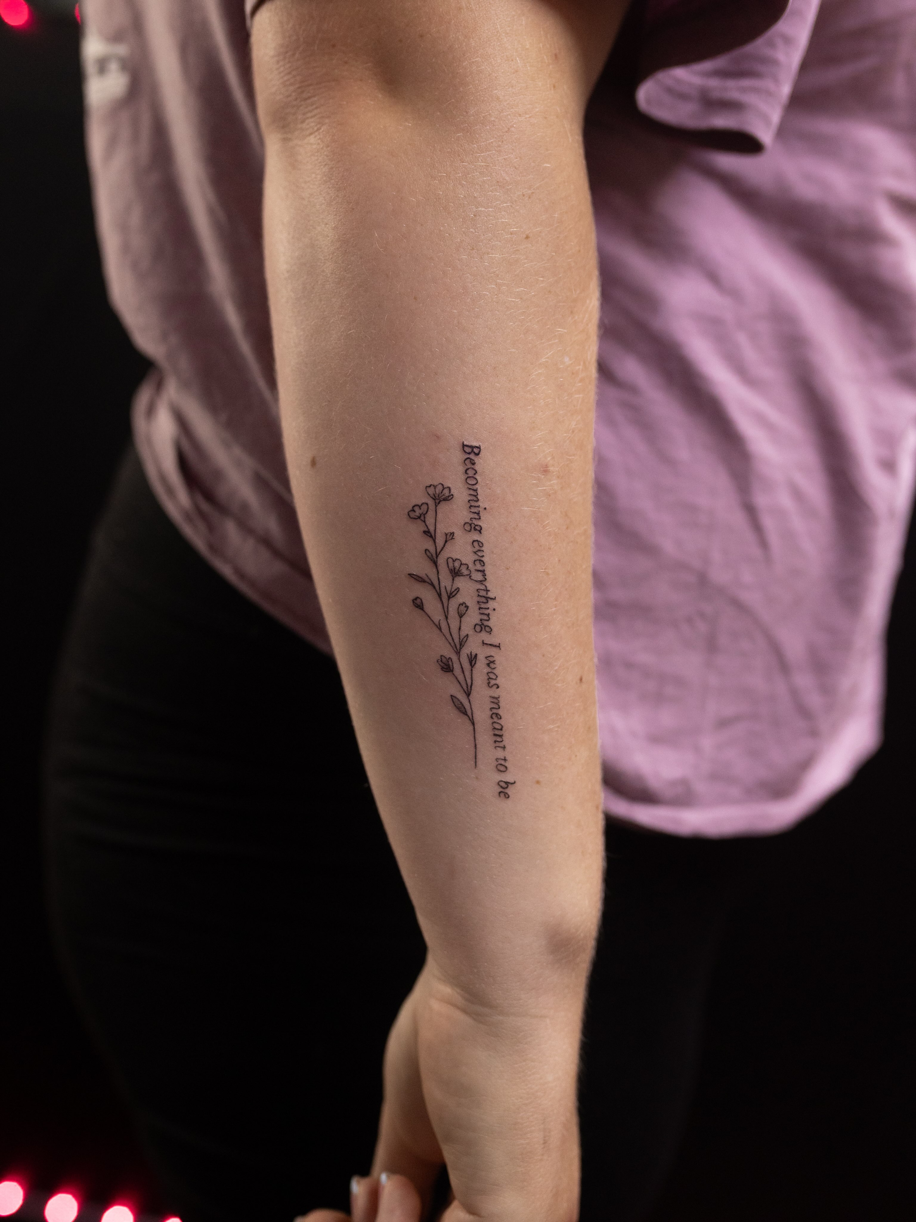 Flower and script fine line tattoo on the forearm by Kelsie