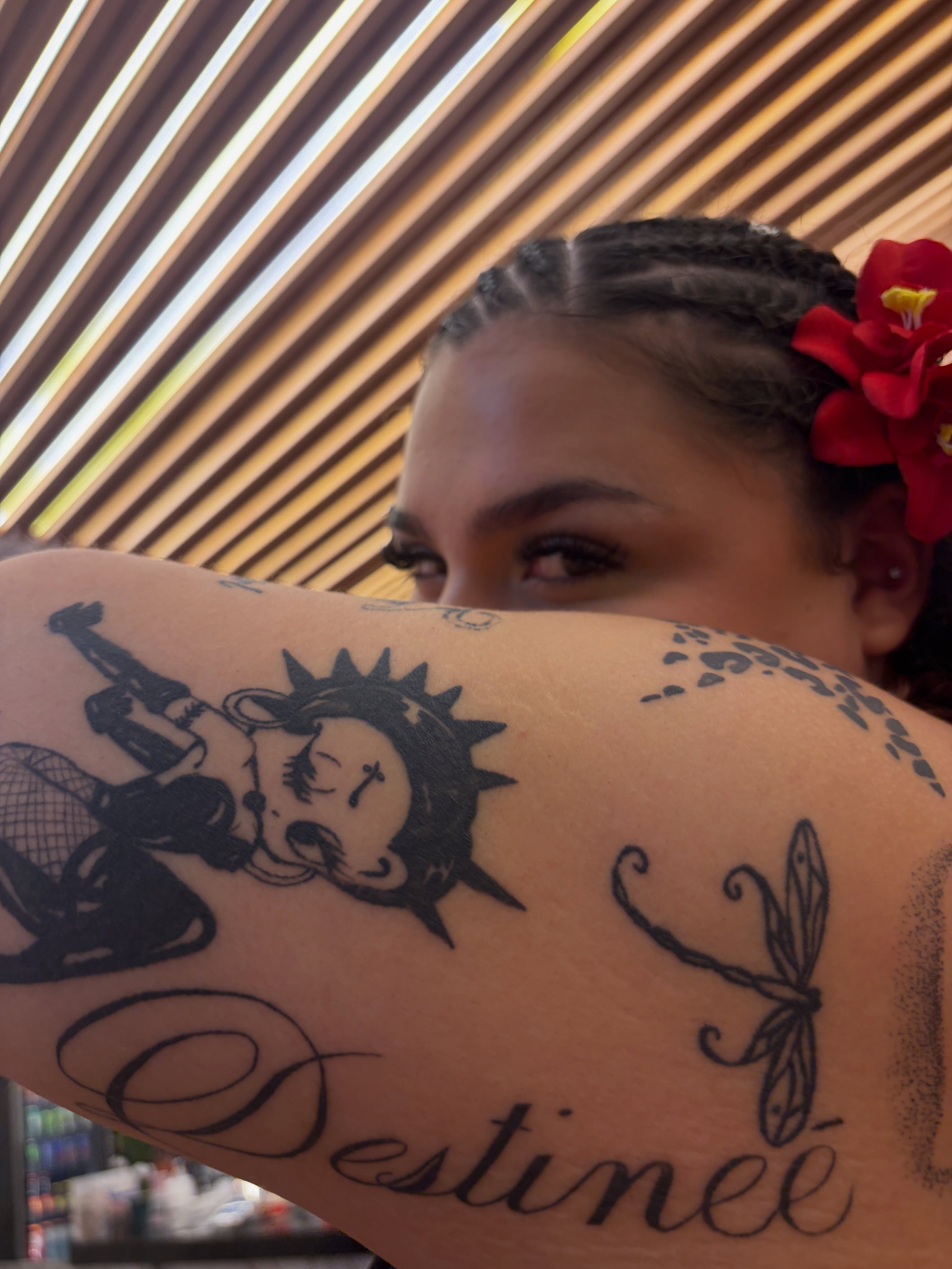 Betty Boop and dragonfly black and grey tattoo on the upper arm by Destineé