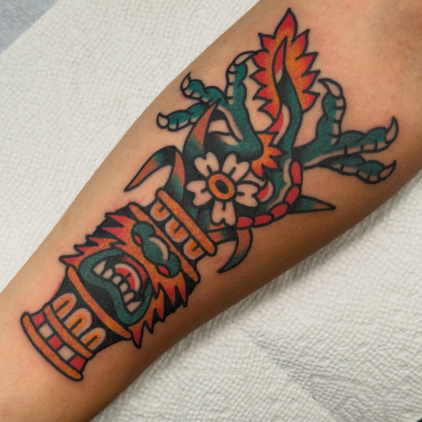Tiki mask American traditional tattoo on the forearm by Rafael Torres, San Francisco, California