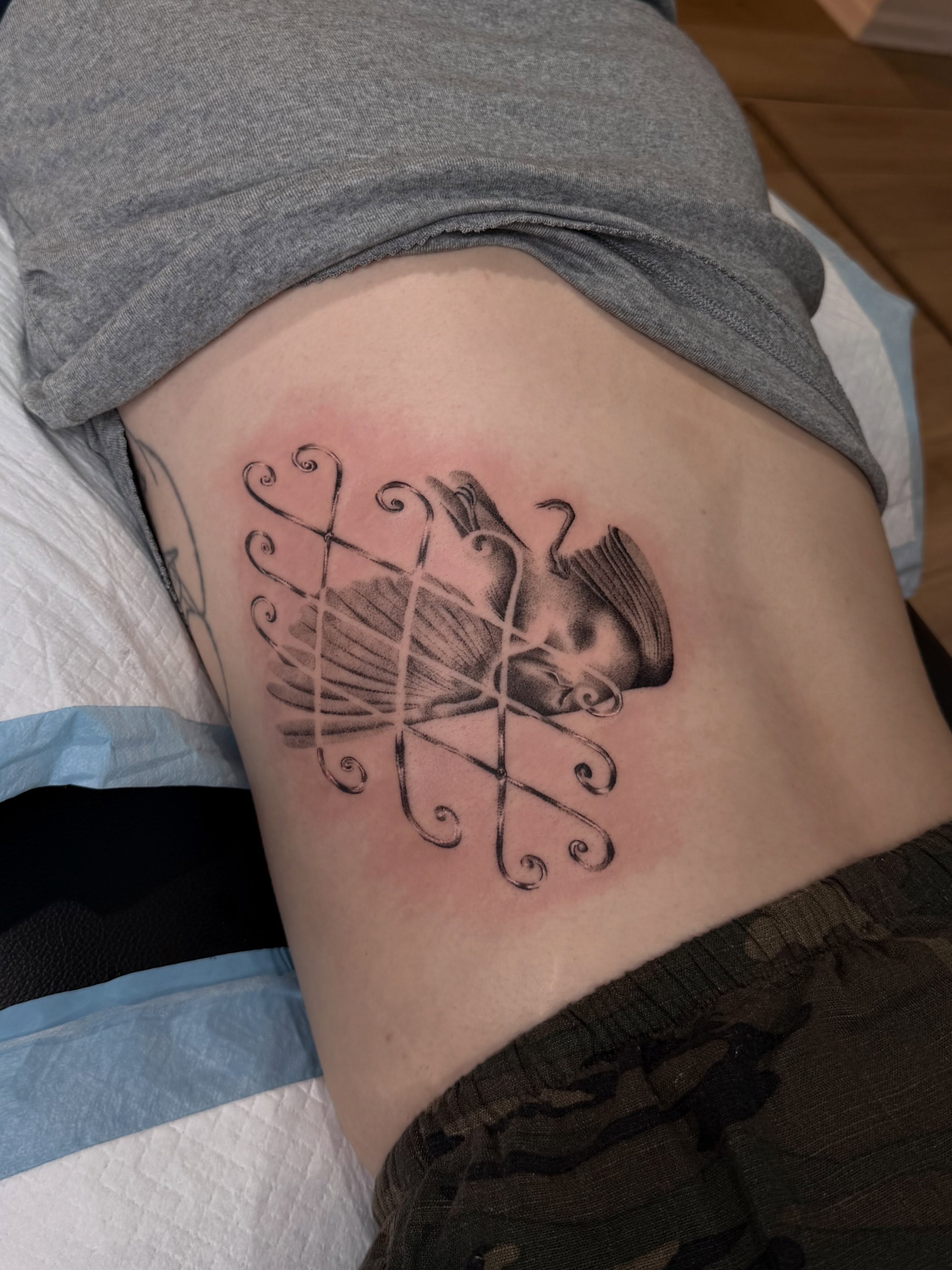 Book and string black and grey tattoo on the ribs by 🗡Addie Kat🗡