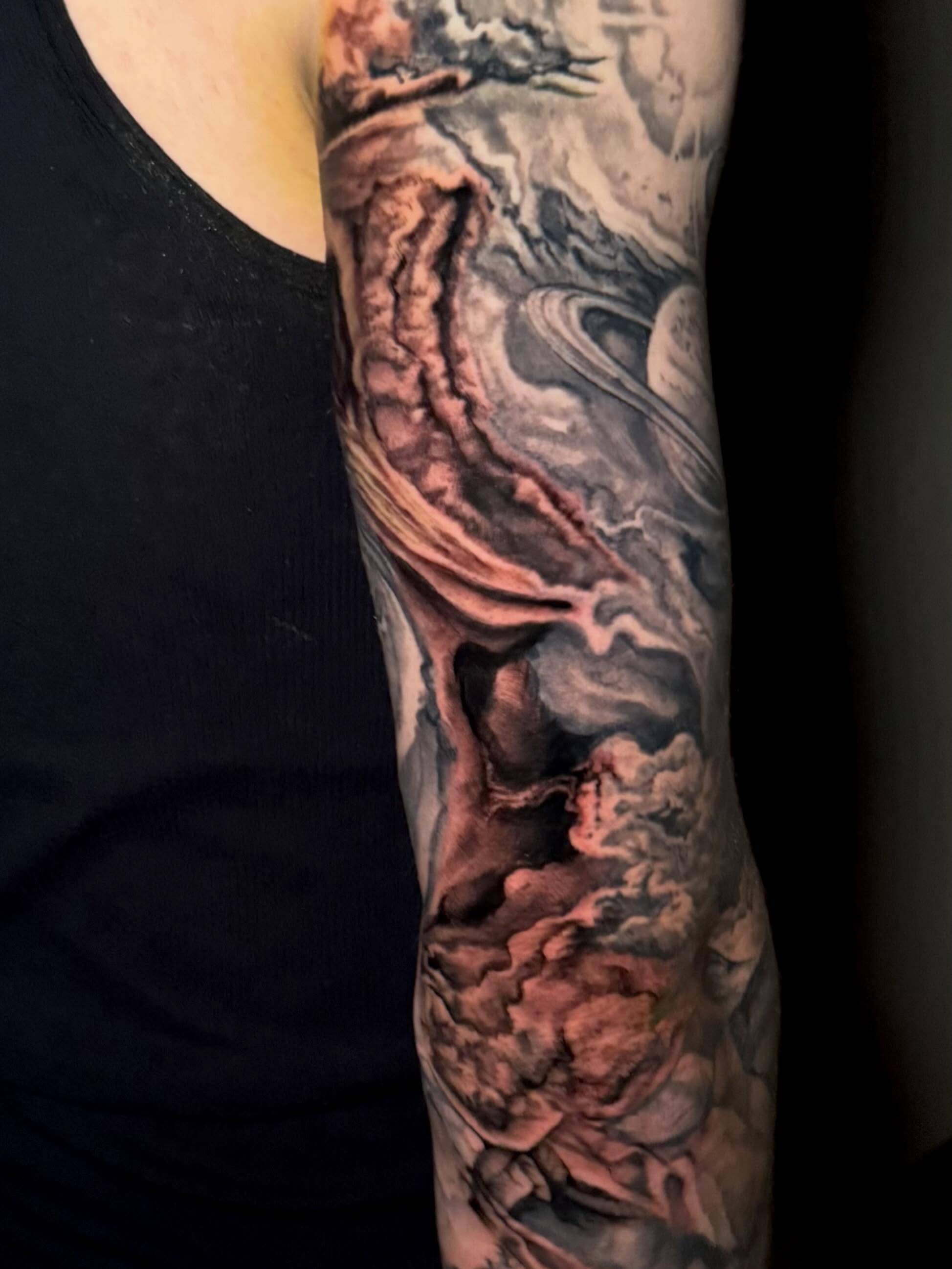 Space landscape realism tattoo on the forearm by Aaron Ysidro