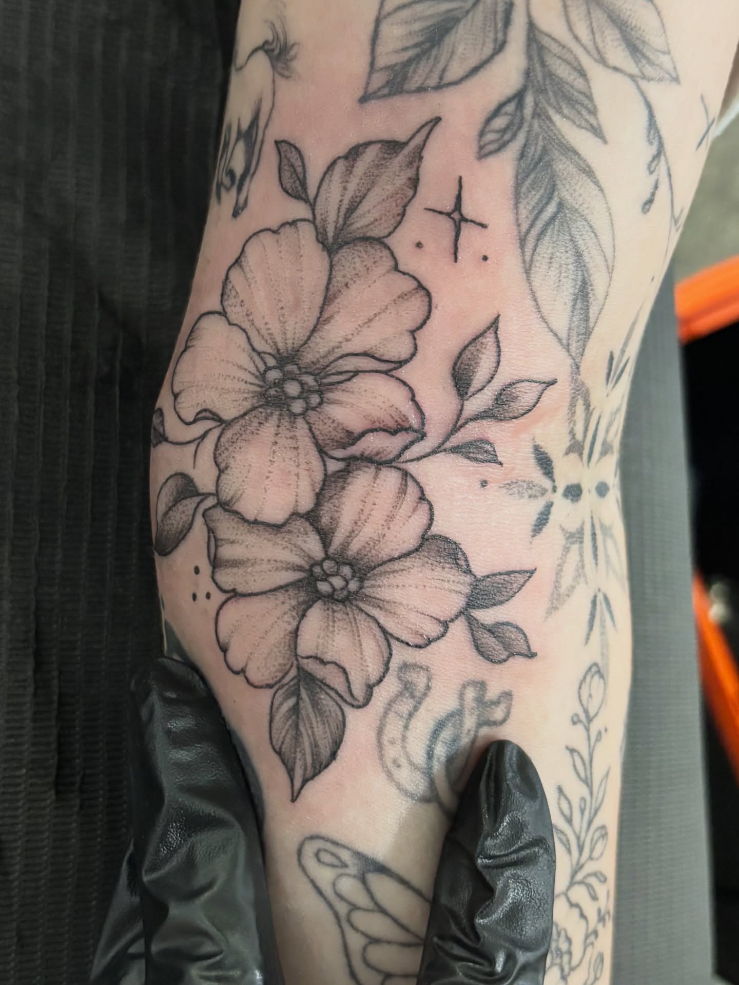 Flowers dotwork tattoo on the forearm by Komfort Kristy