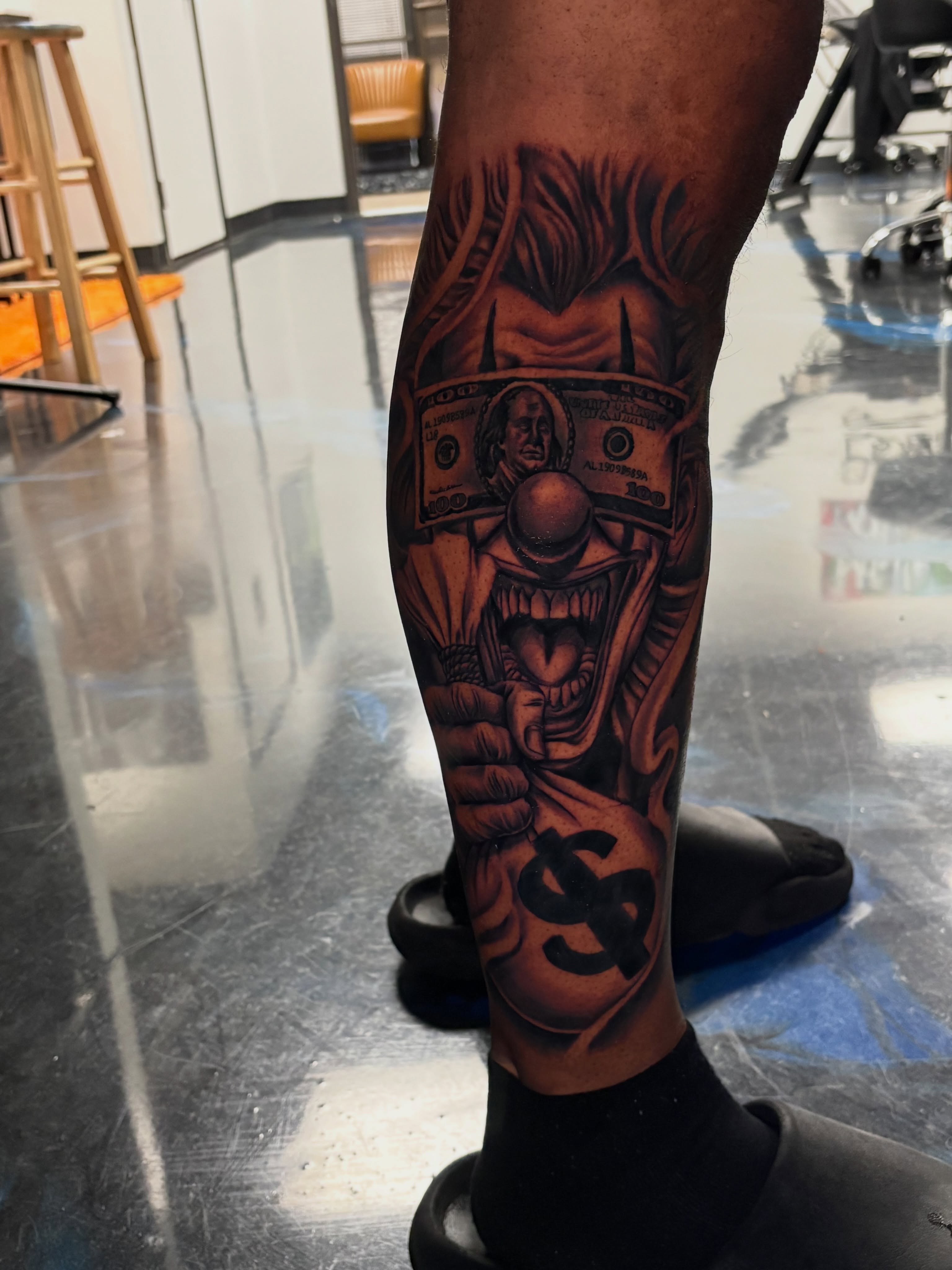 Money monster dark realism tattoo on the calf by Vonte Seay