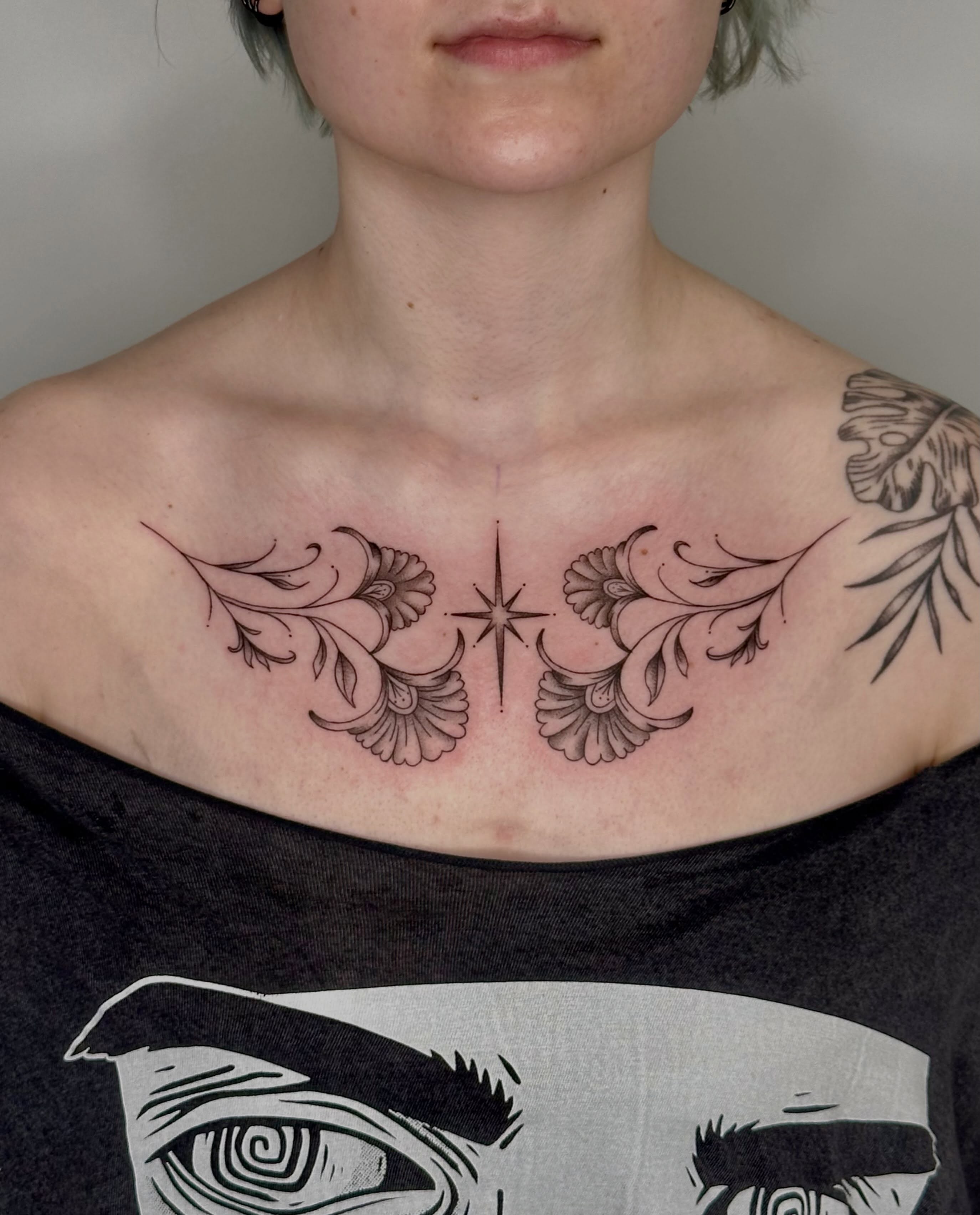 Feather and star black and grey tattoo on the chest by 🌼Kristen Kooster Tattoos🌼