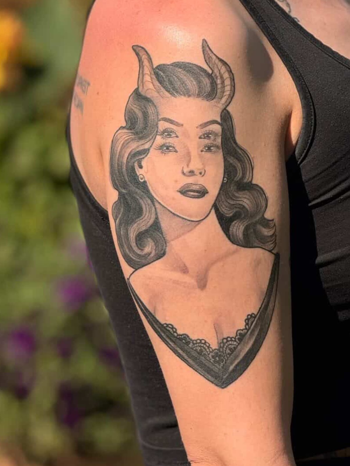 Woman with horns realism tattoo on the upper arm by Tanya Murski