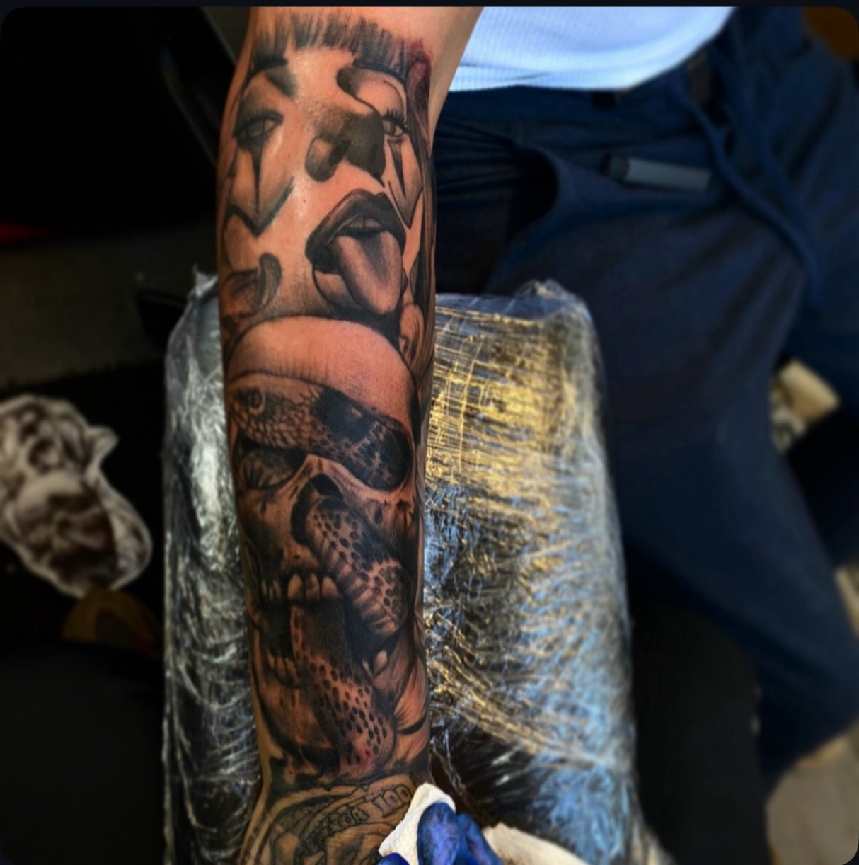 Skull and snake realism tattoo on the forearm by Lamb, Philadelphia, Pennsylvania
