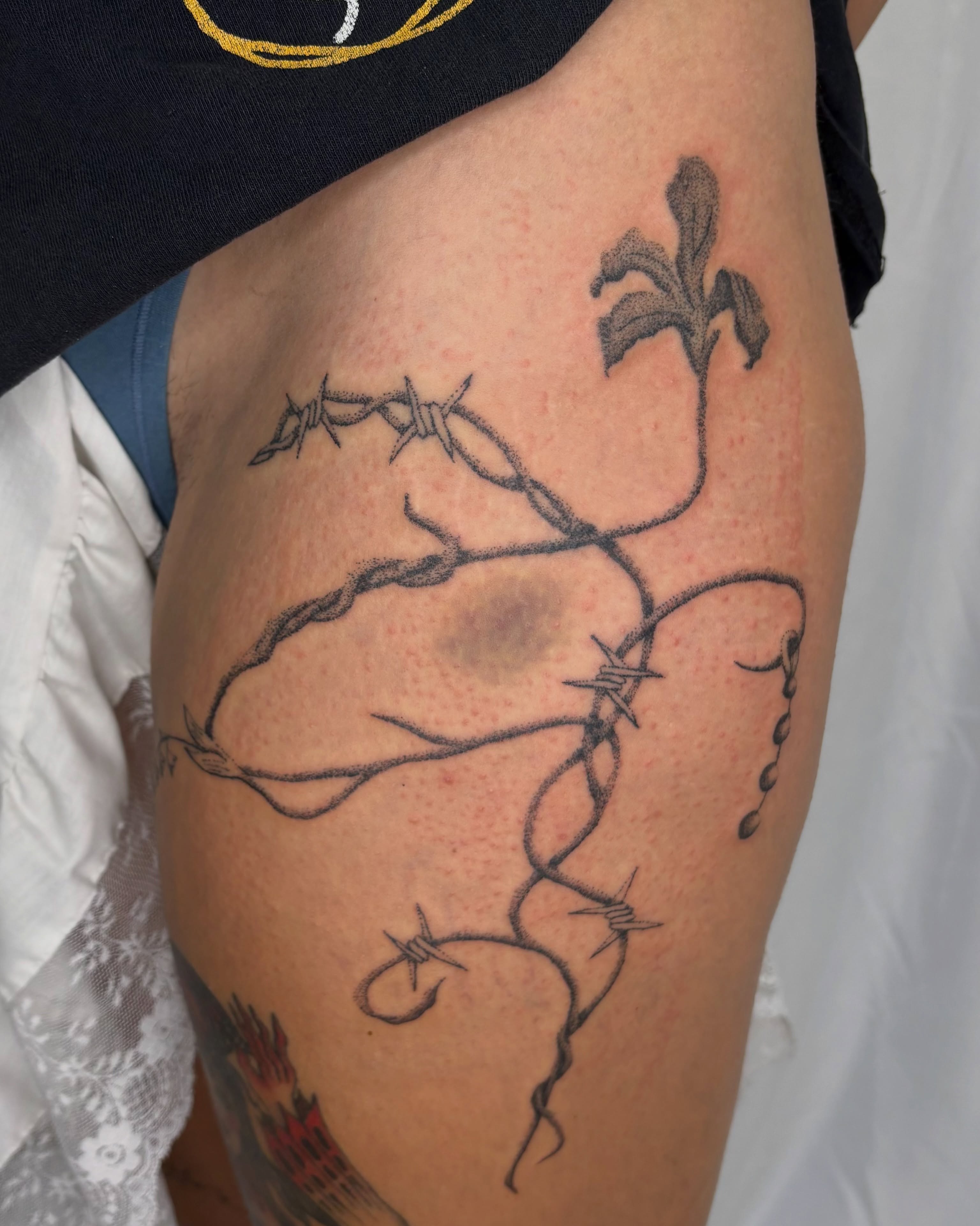 Barbed wire and flower black and grey tattoo on the thigh by sabrina ✿ ◔ ں ◔ ✿ san francisco tattoo!