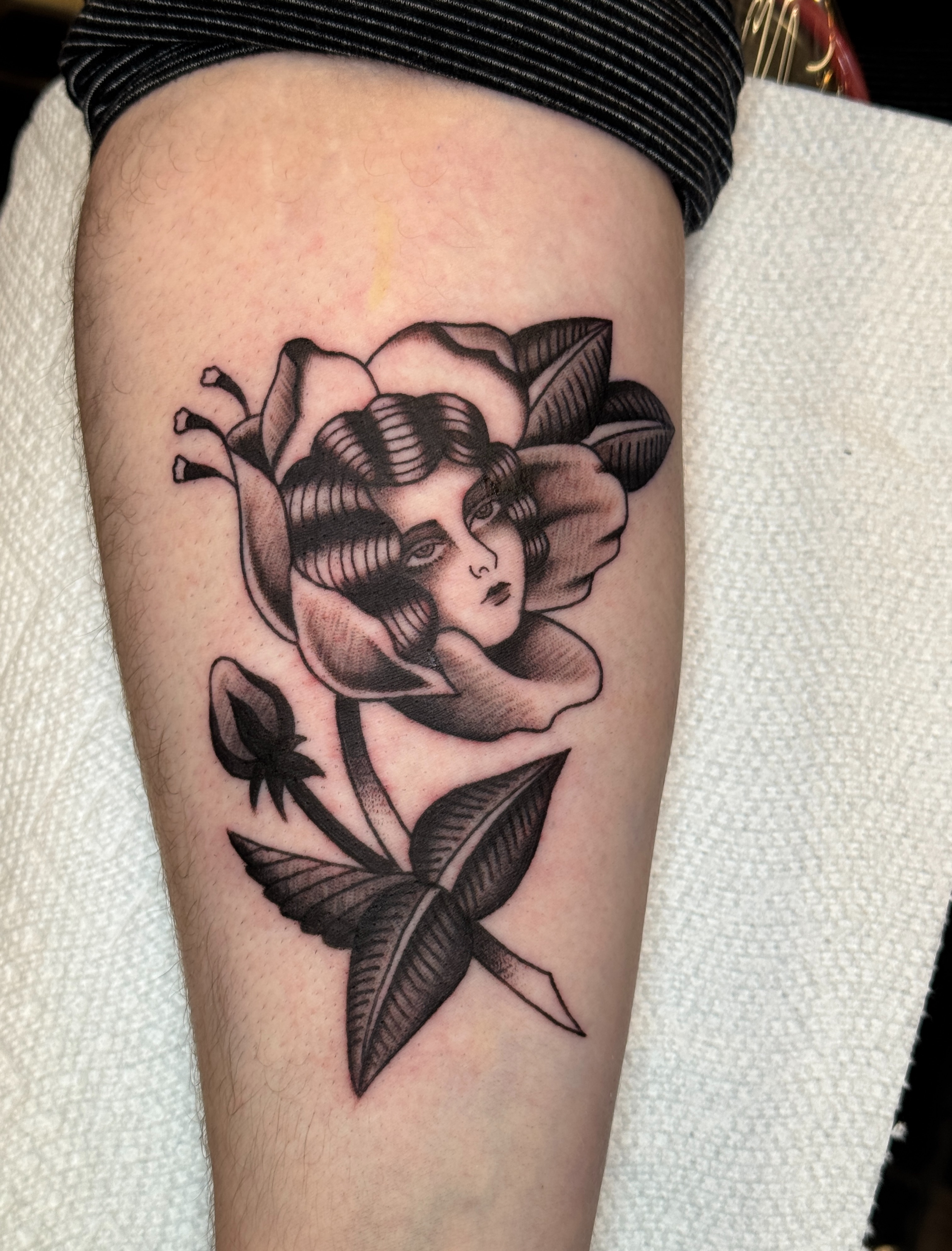 Flower with woman American traditional tattoo on the thigh by Allie Barringer