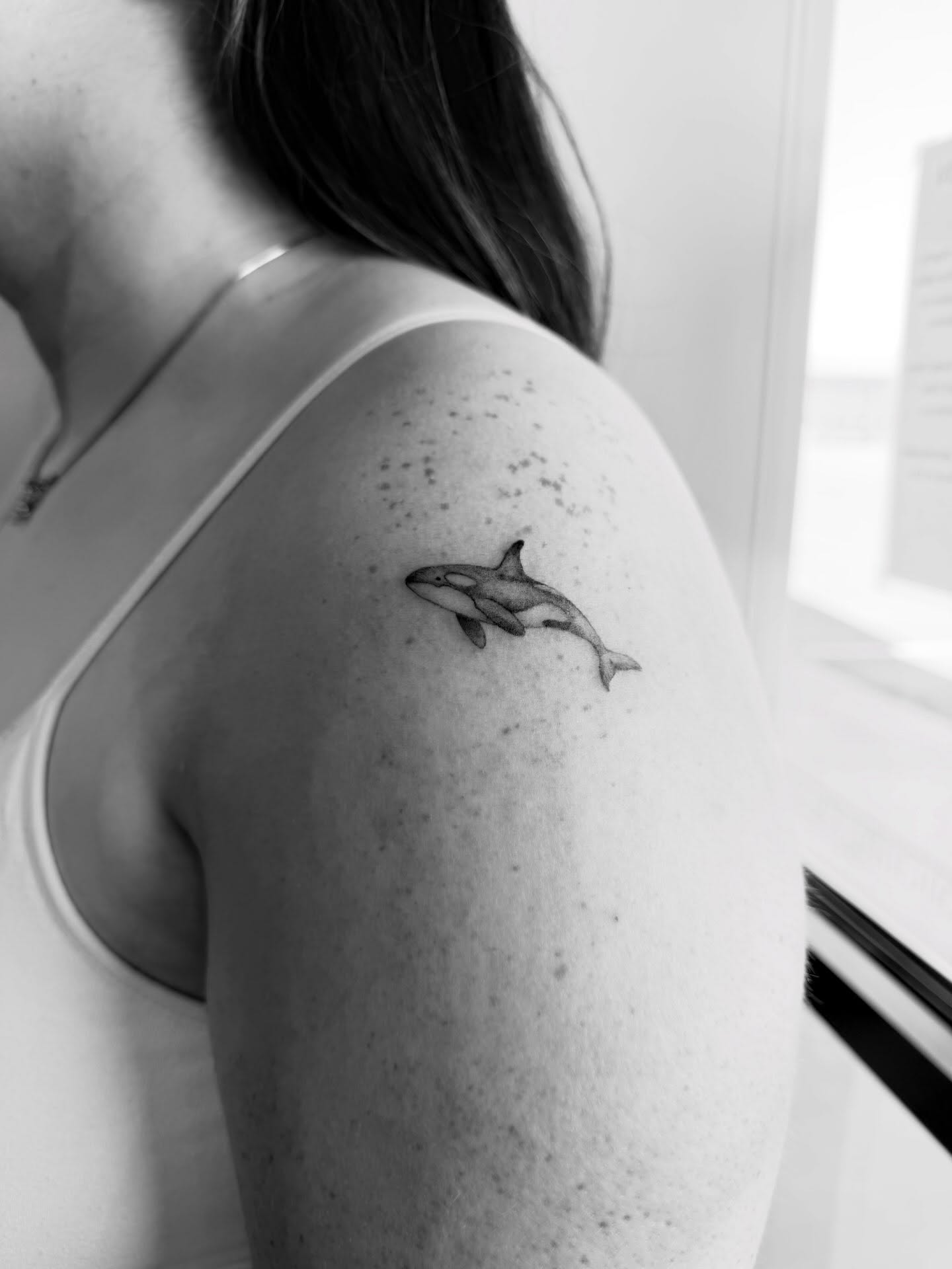 Orca whale black and grey tattoo on the shoulder by Reverie Studio