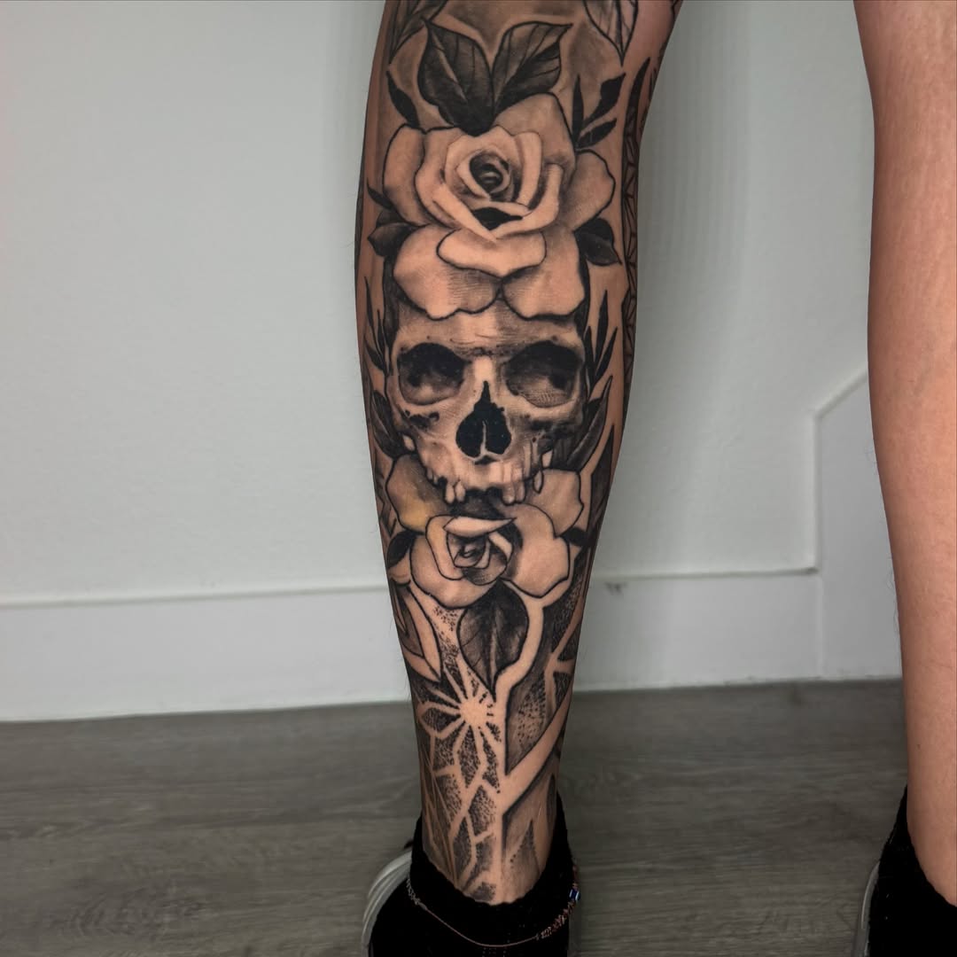 Skull and roses realism tattoo on the calf by James ⚡️ Tattoo Artist