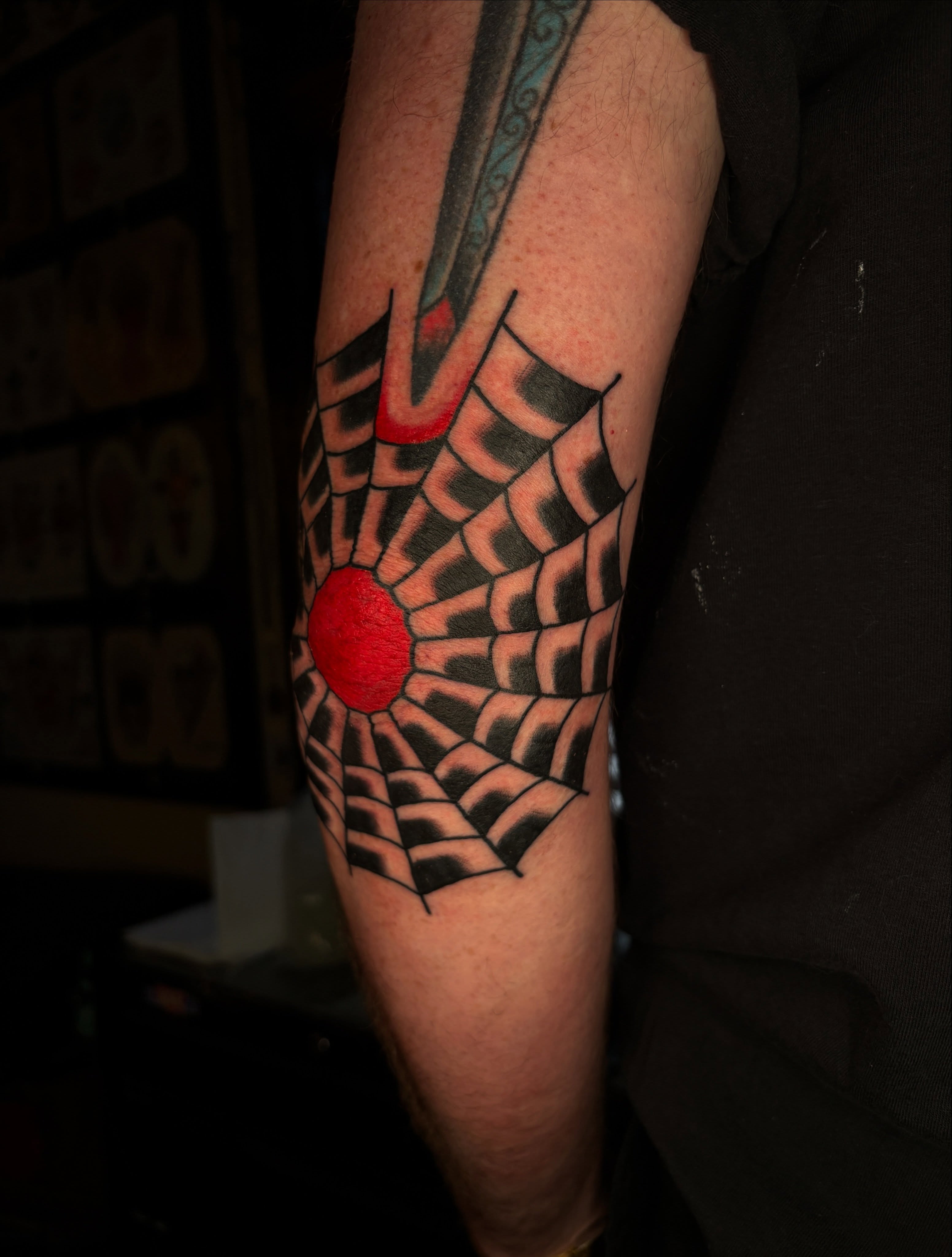 Spiderweb geometric tattoo on the forearm by Max Klapp, Austin, Texas