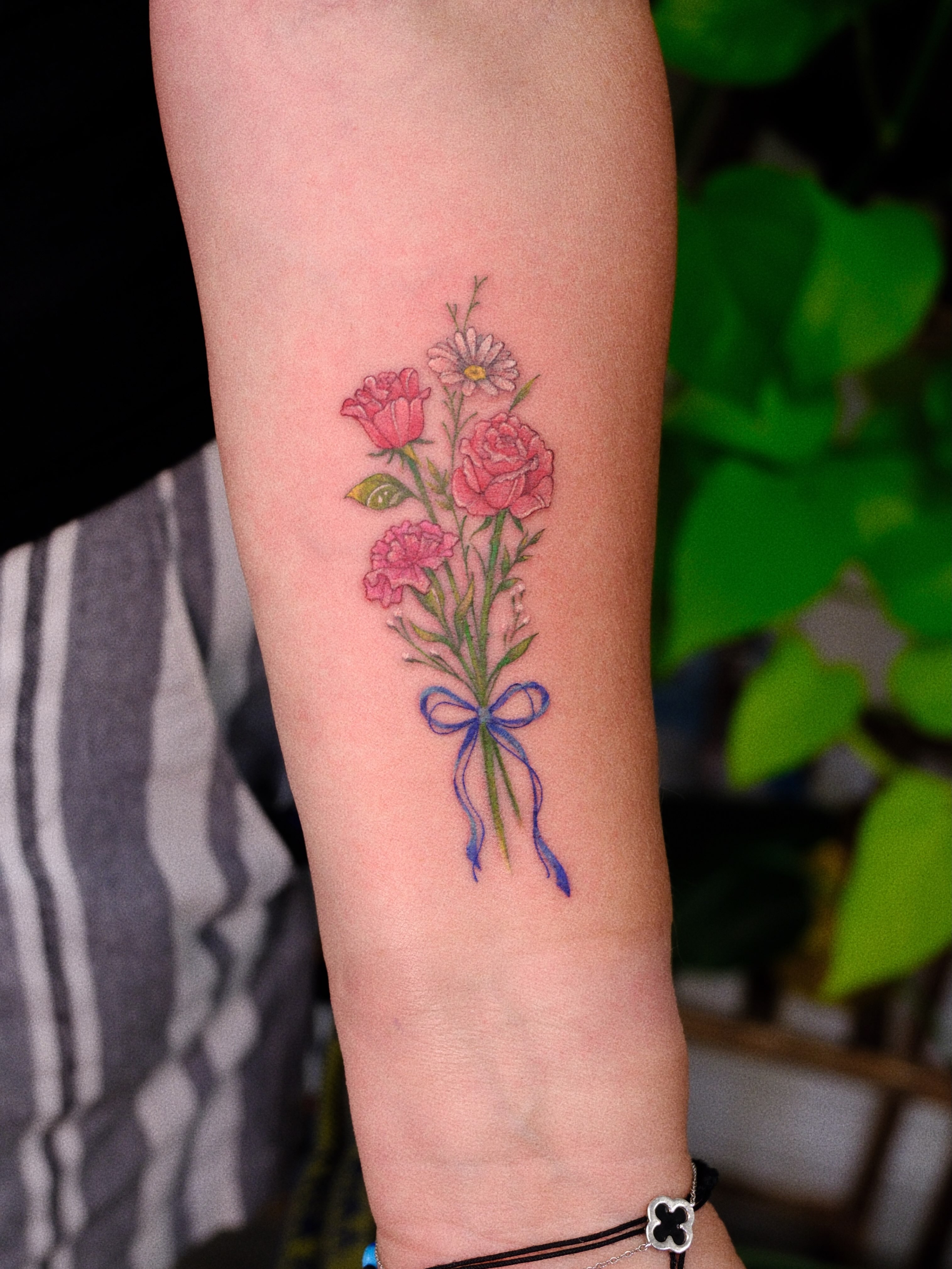 Flower bouquet realism tattoo on the forearm by rita_tattooist