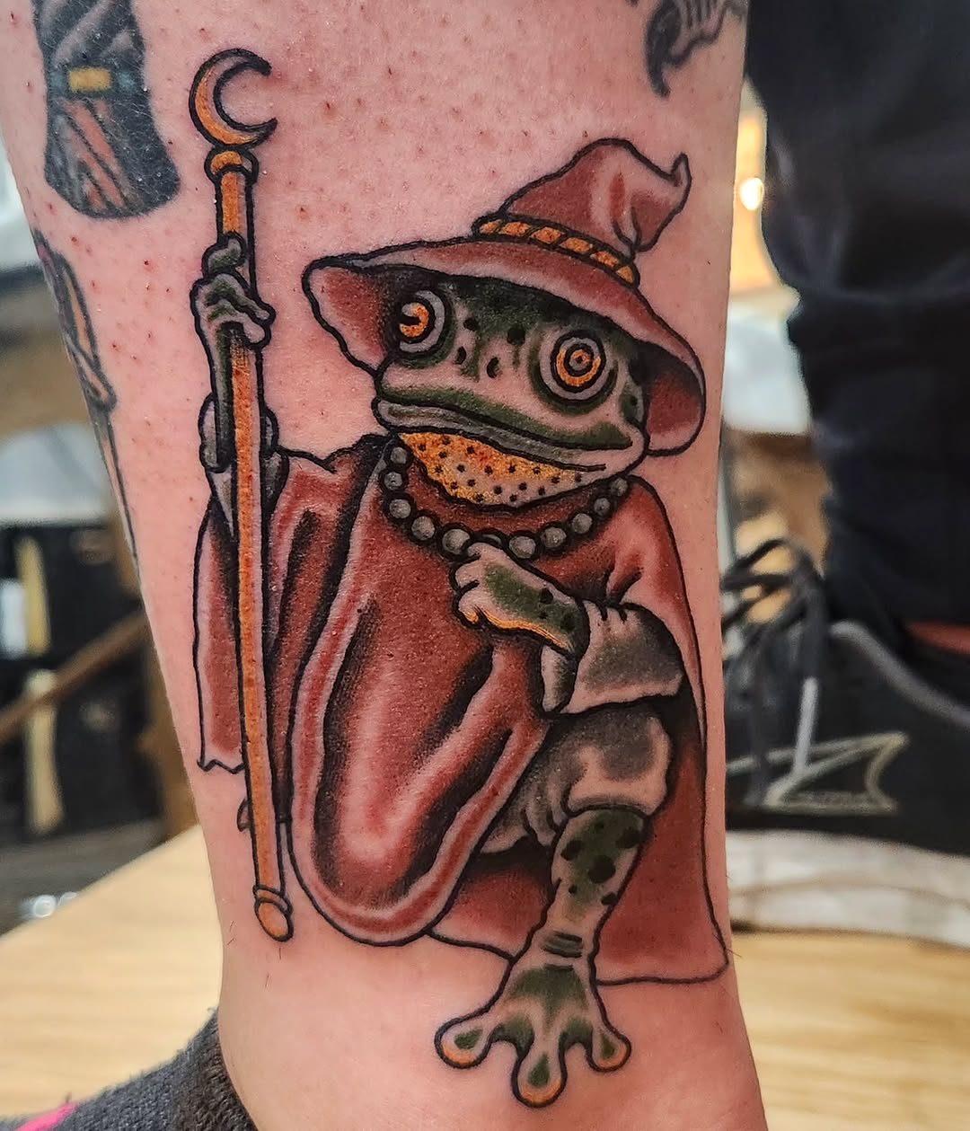 Wizard frog American traditional tattoo on the forearm by Douglas Grady
