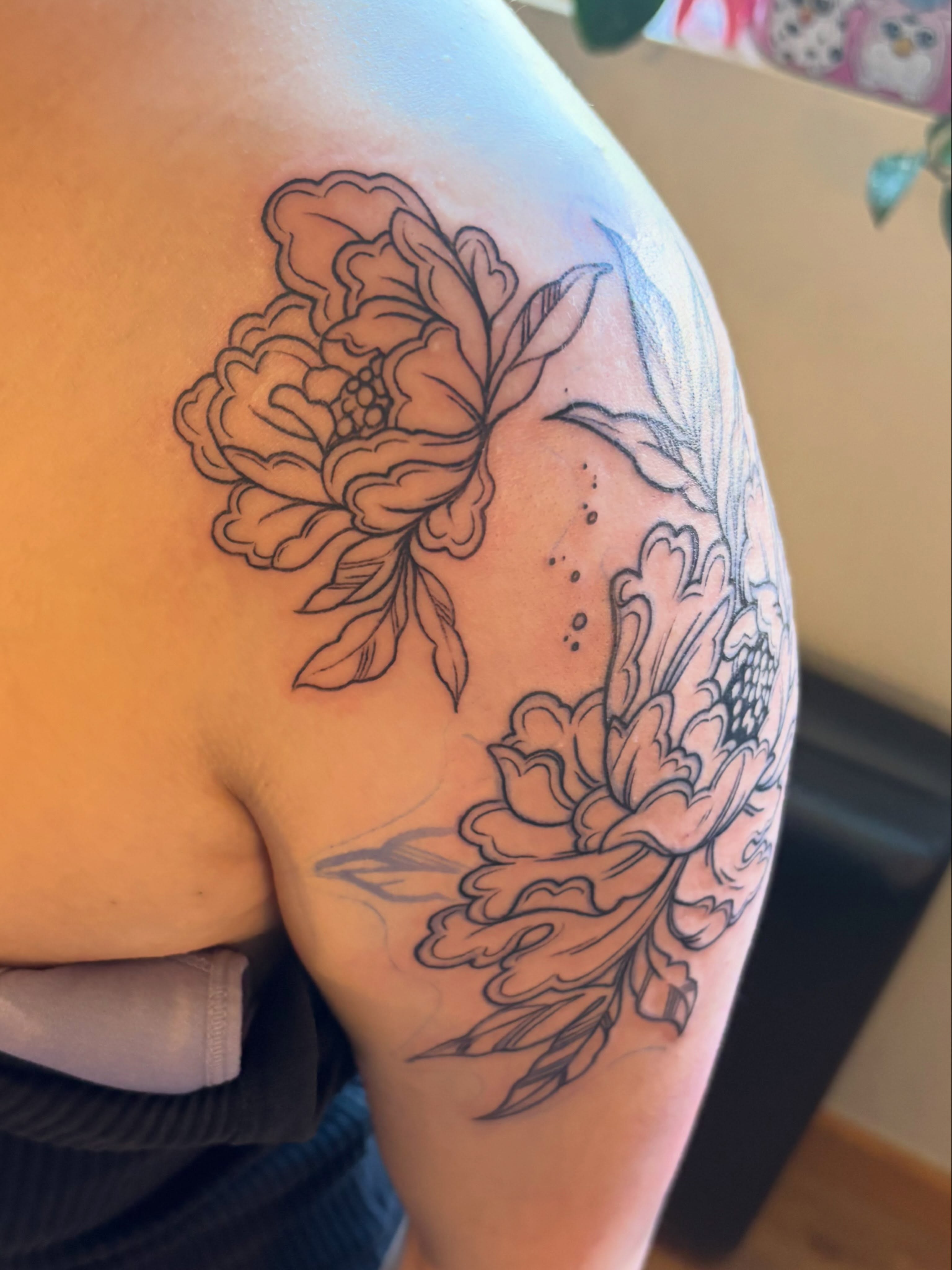 Peony black and grey tattoo on the shoulder by Zoe Brookes