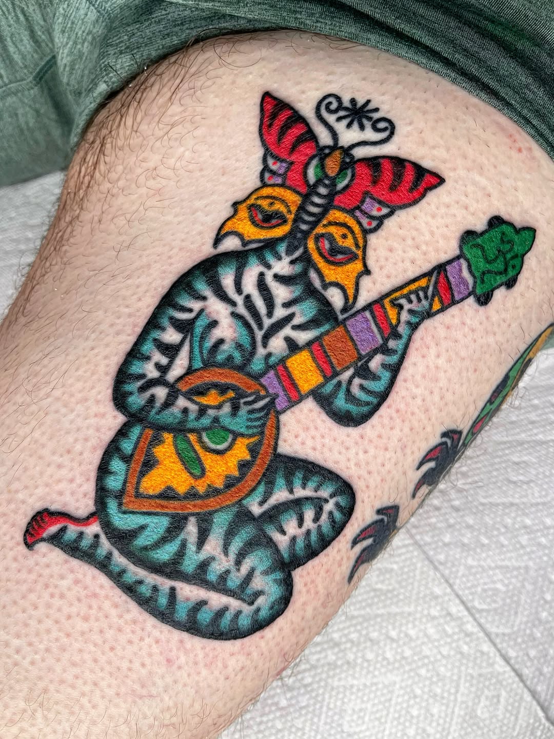 Creature playing an instrument American traditional tattoo on the thigh by Swasthik Iyengar, New York, New York