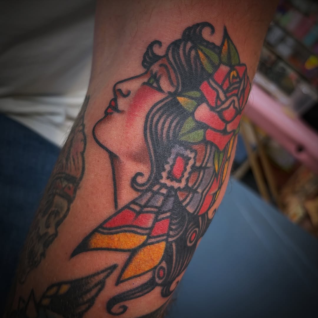 Woman with floral crown American traditional tattoo on the forearm by Deya Aven, Nashville, Tennessee