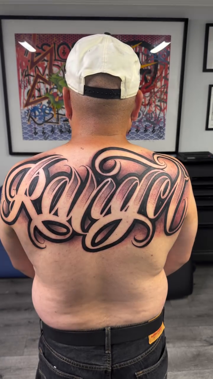 Tattoo by @rockyg_inkz — lettering_script, chicano