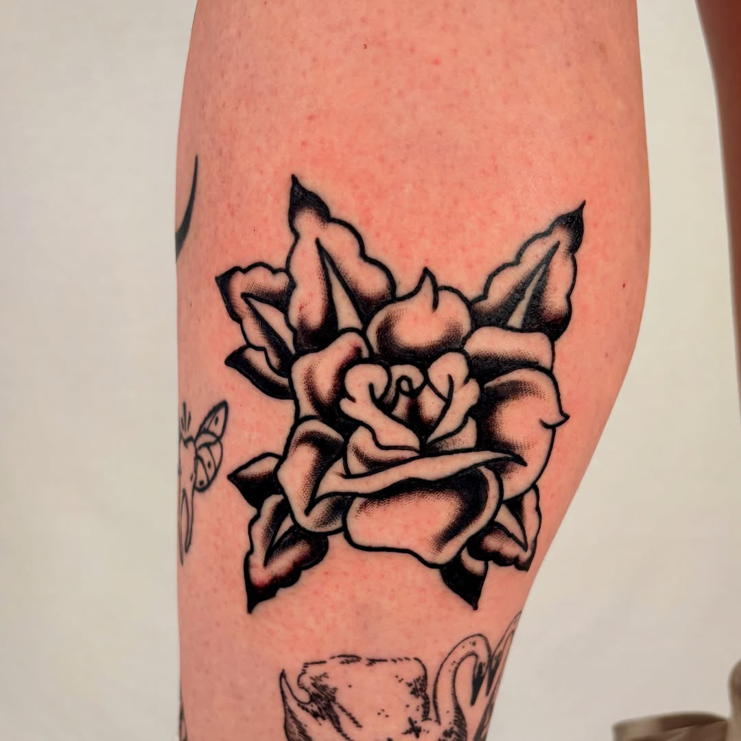 Rose American traditional tattoo on the forearm by Davie Tattoos