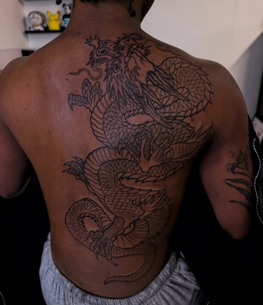 Dragon black and grey tattoo on the back by Melissa "Lotuss" Chan