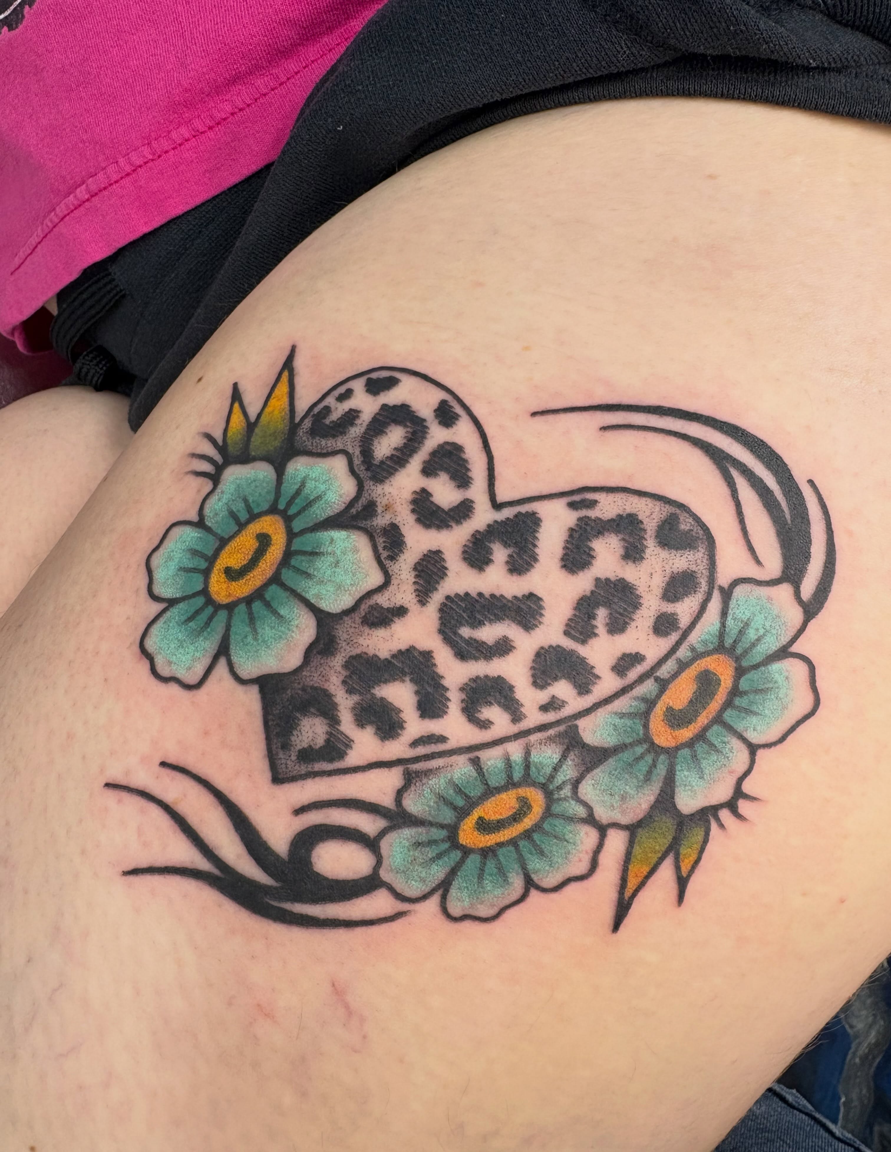 Leopard heart with flowers American traditional tattoo on the thigh by Abbey Martin, Nashville, Tennessee