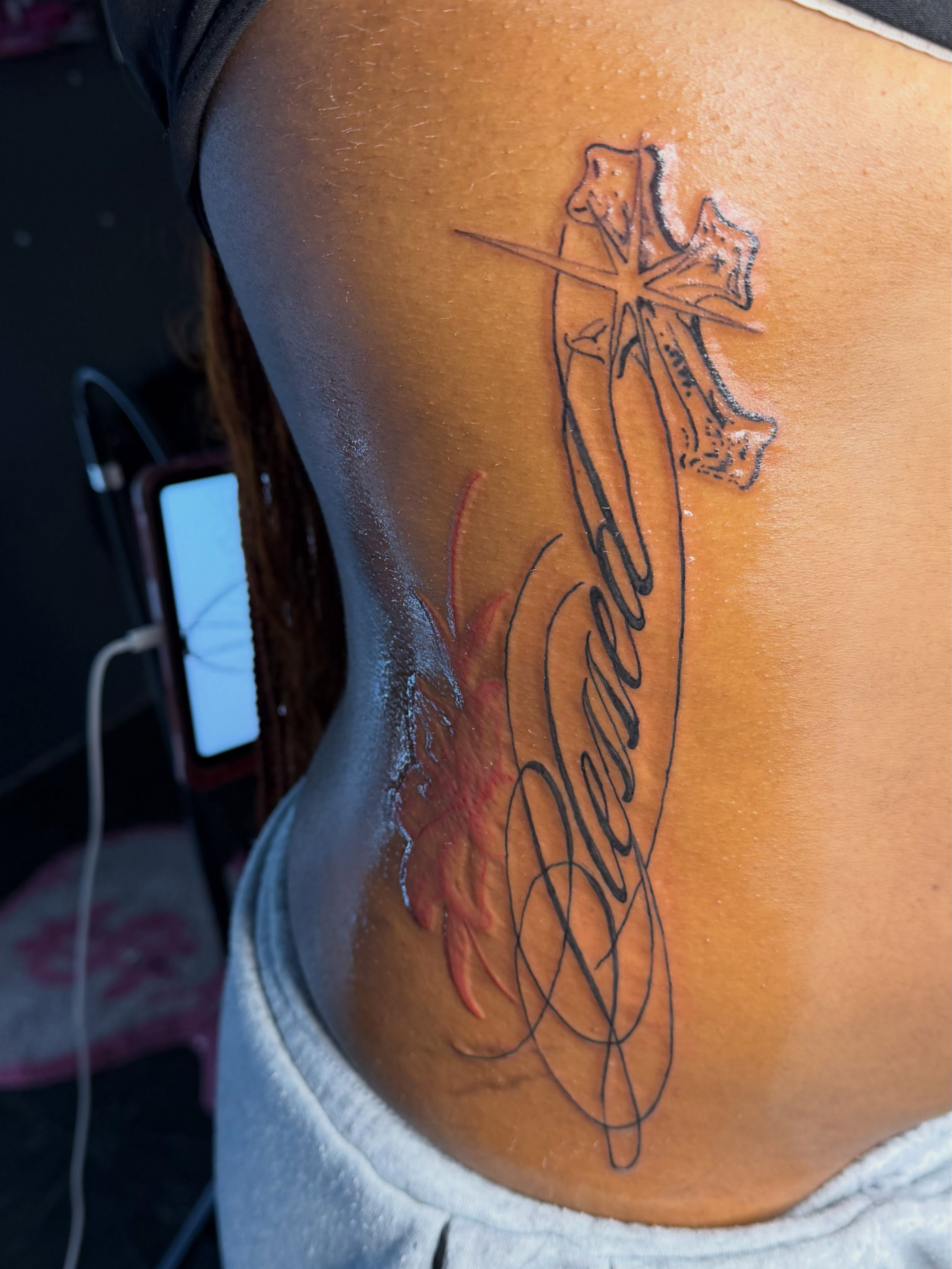 Cross with flame lettering script tattoo on the ribs by addicted222inkk🎨