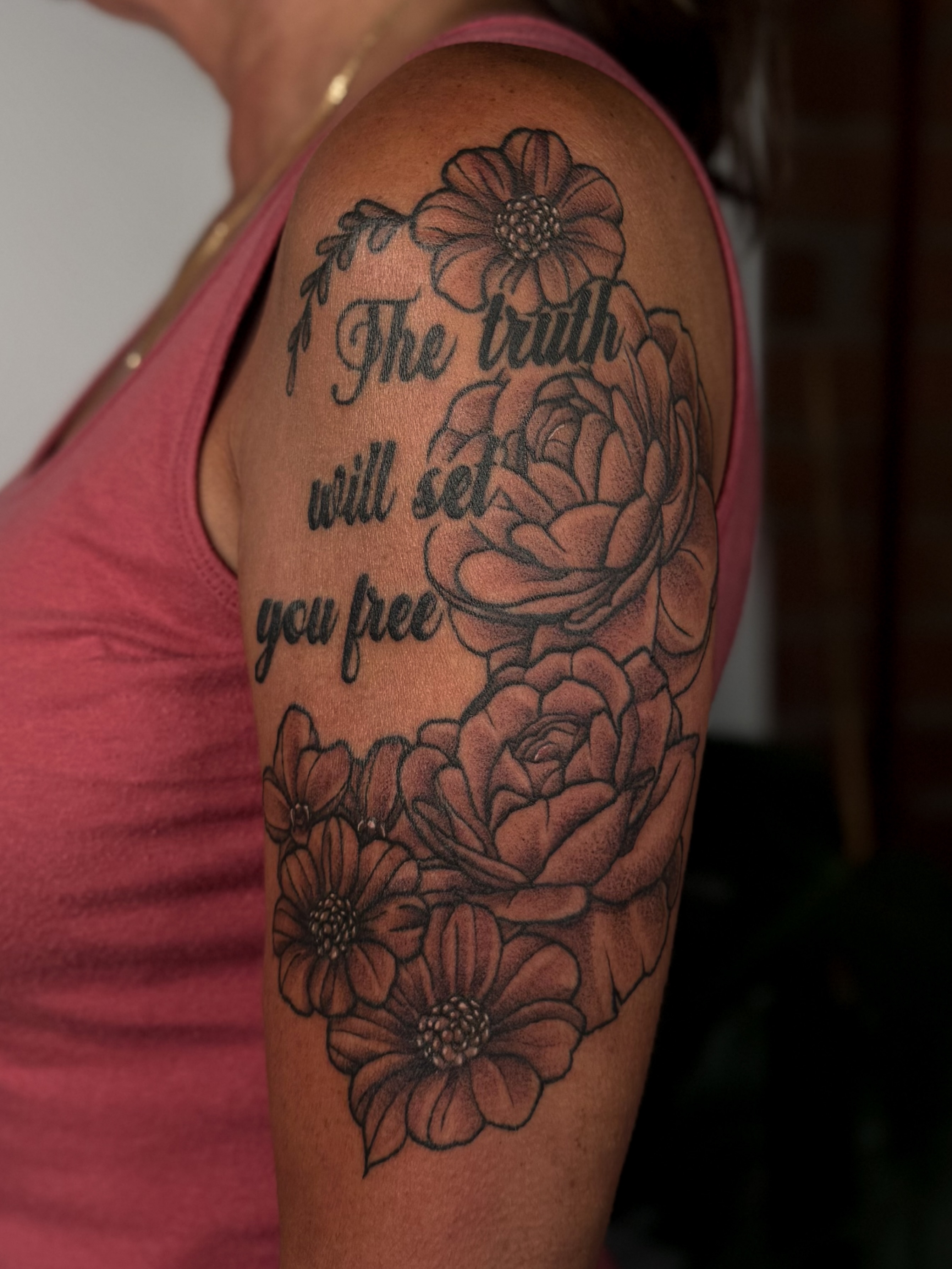 The truth will set you free black and grey tattoo on the upper arm by Jessica Bloom