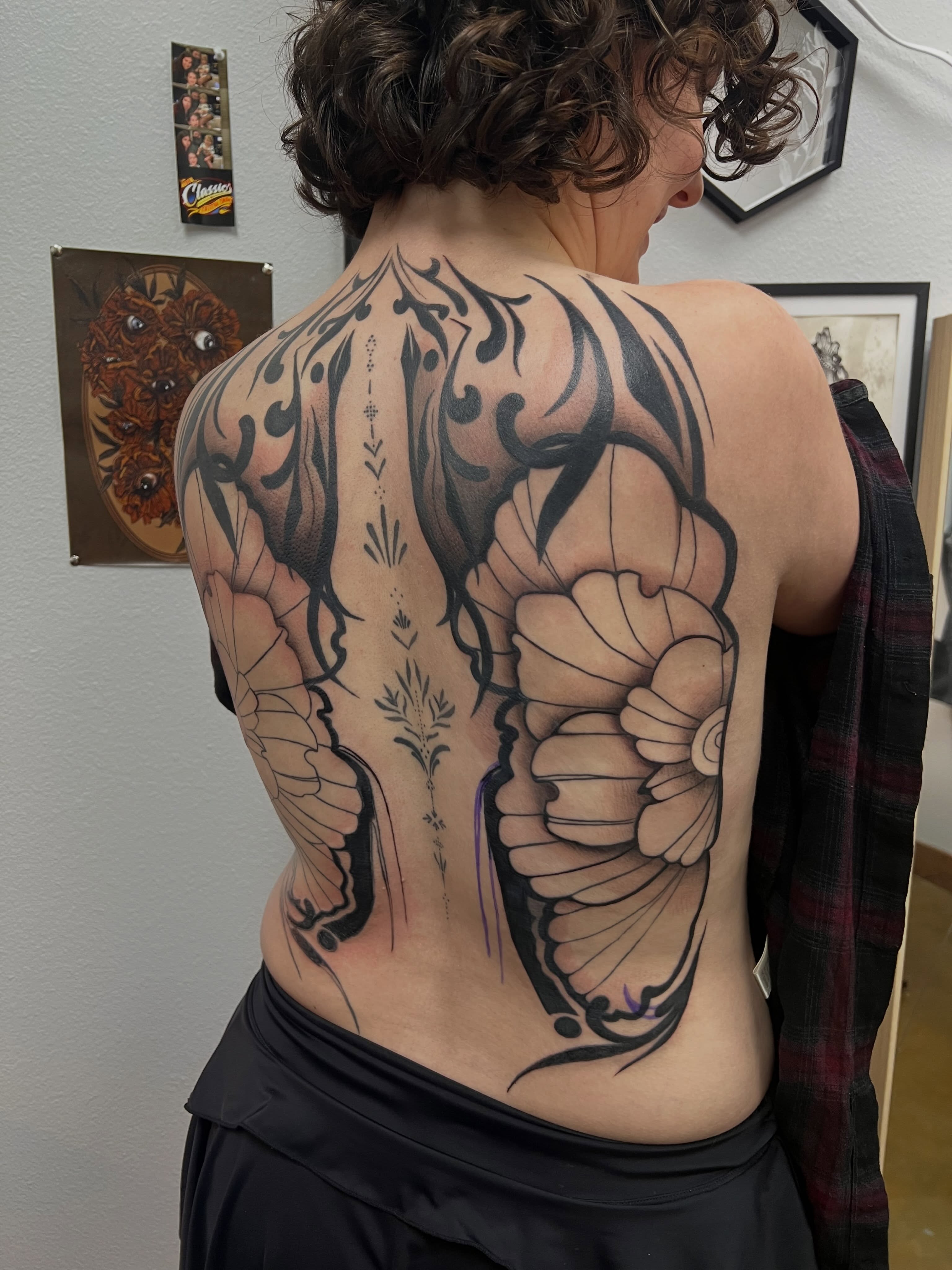 Butterfly and flower tribal tattoo on the back by Rebecca Kern Tattoos