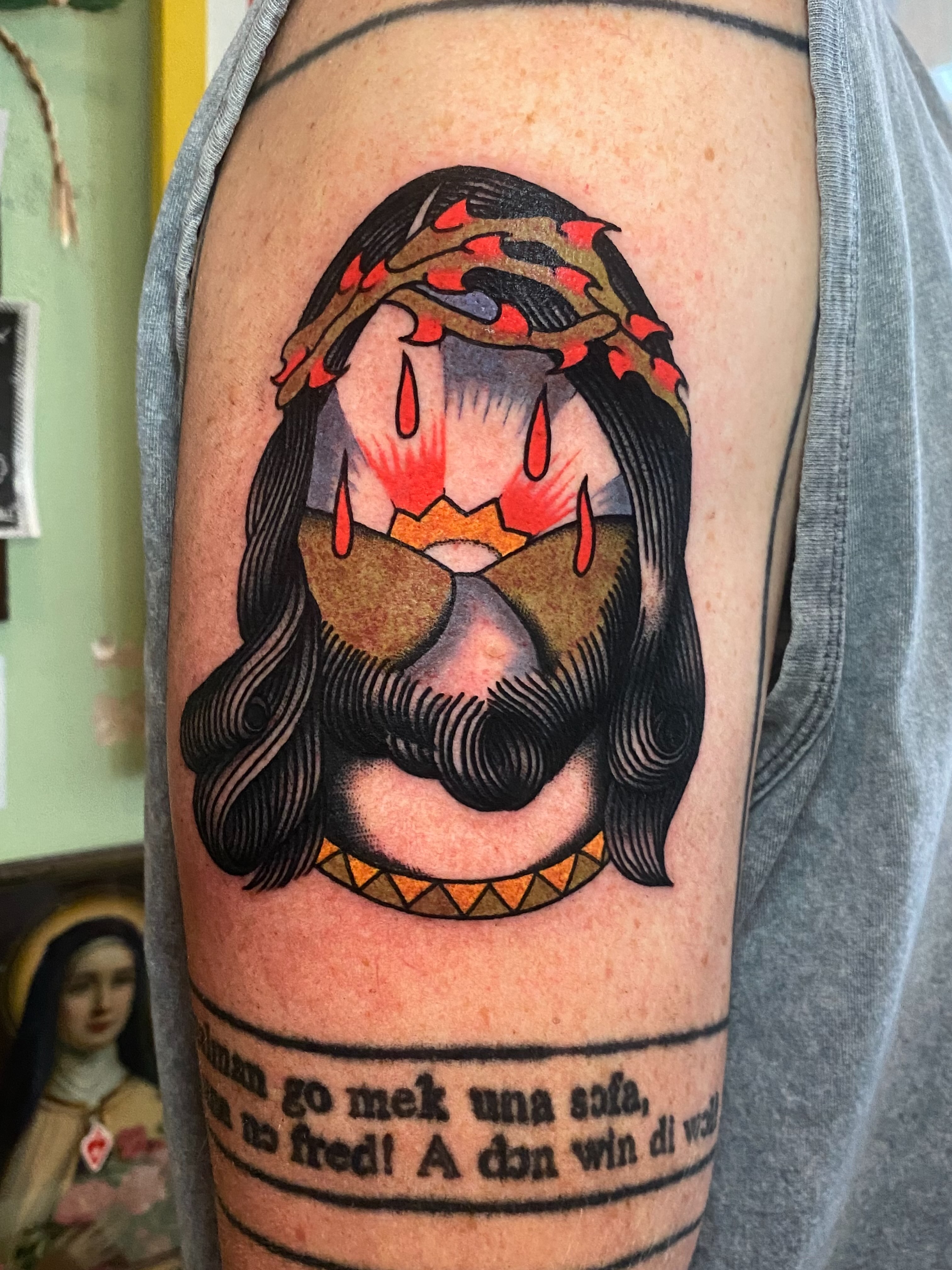 Religious figure American traditional tattoo on the upper arm by Jaclin Grace Hastings