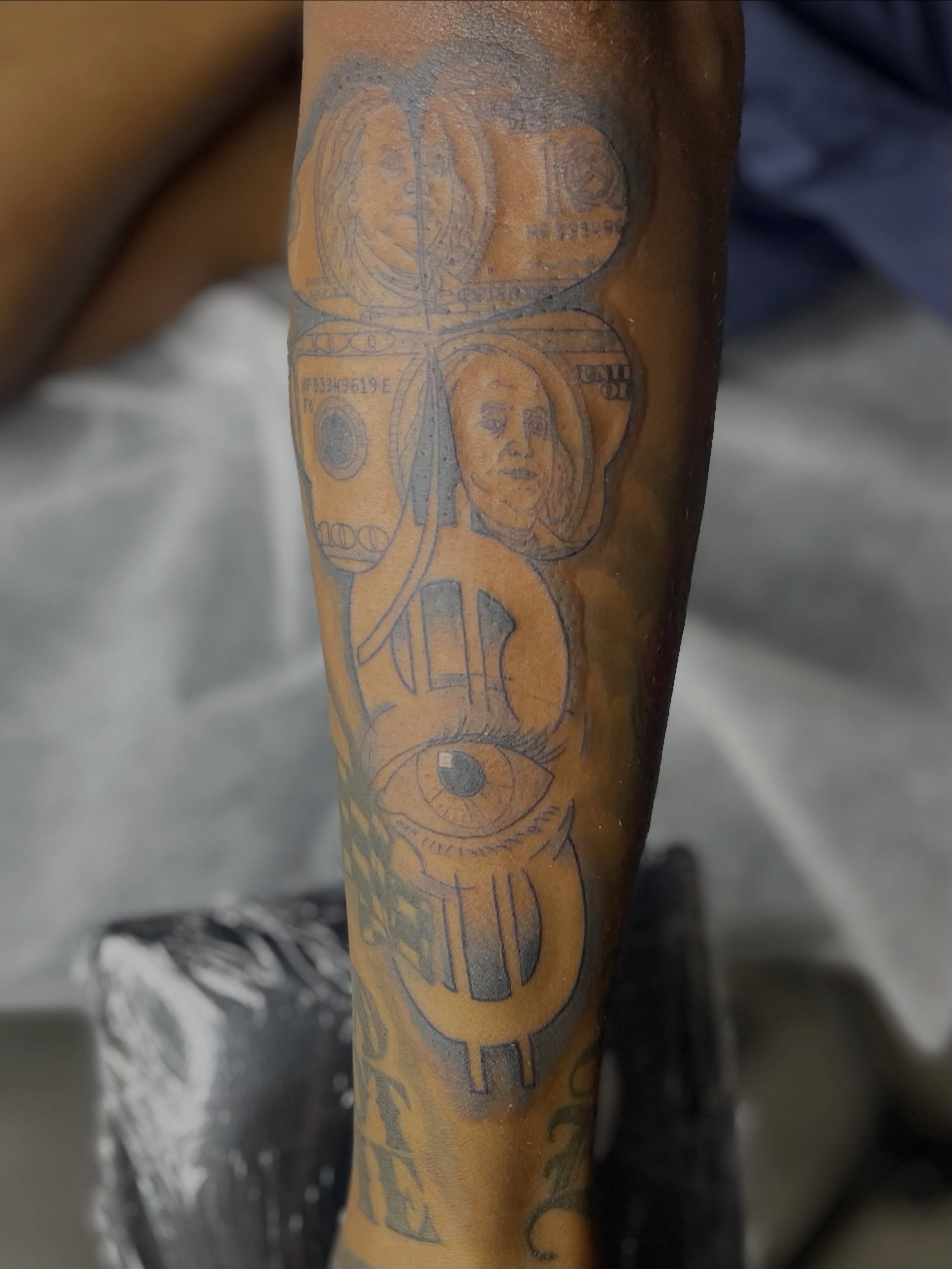 Astronaut and dollar bill American traditional tattoo on the forearm by 😈headhuncho😈