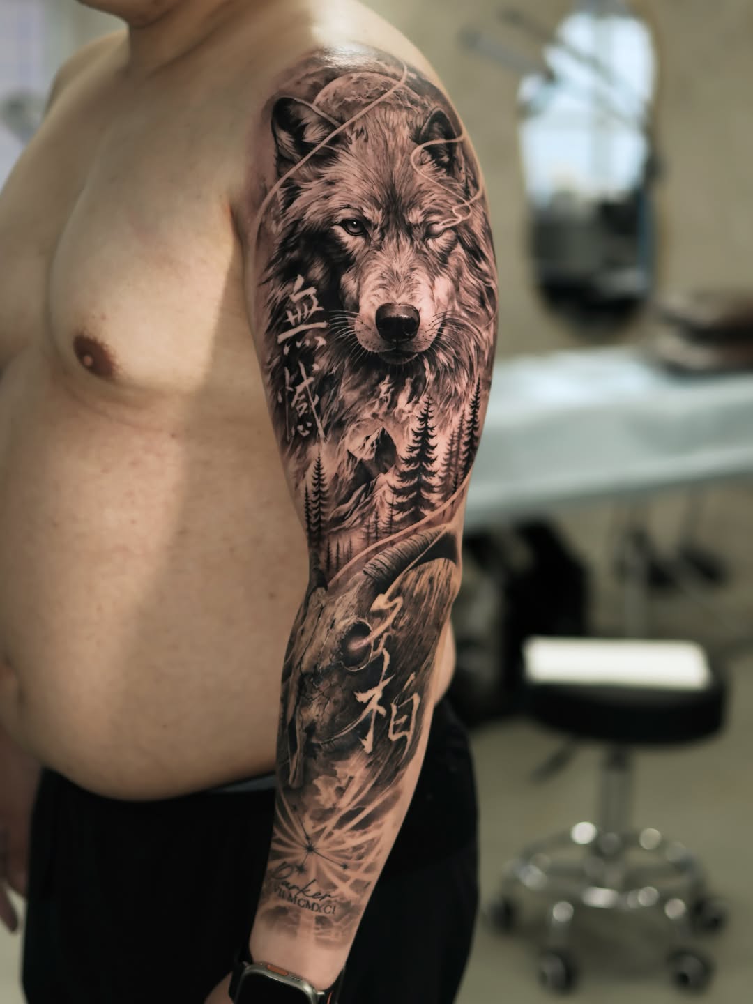 Wolf and goat skull with mountains realism tattoo on the forearm by Reset tattoo