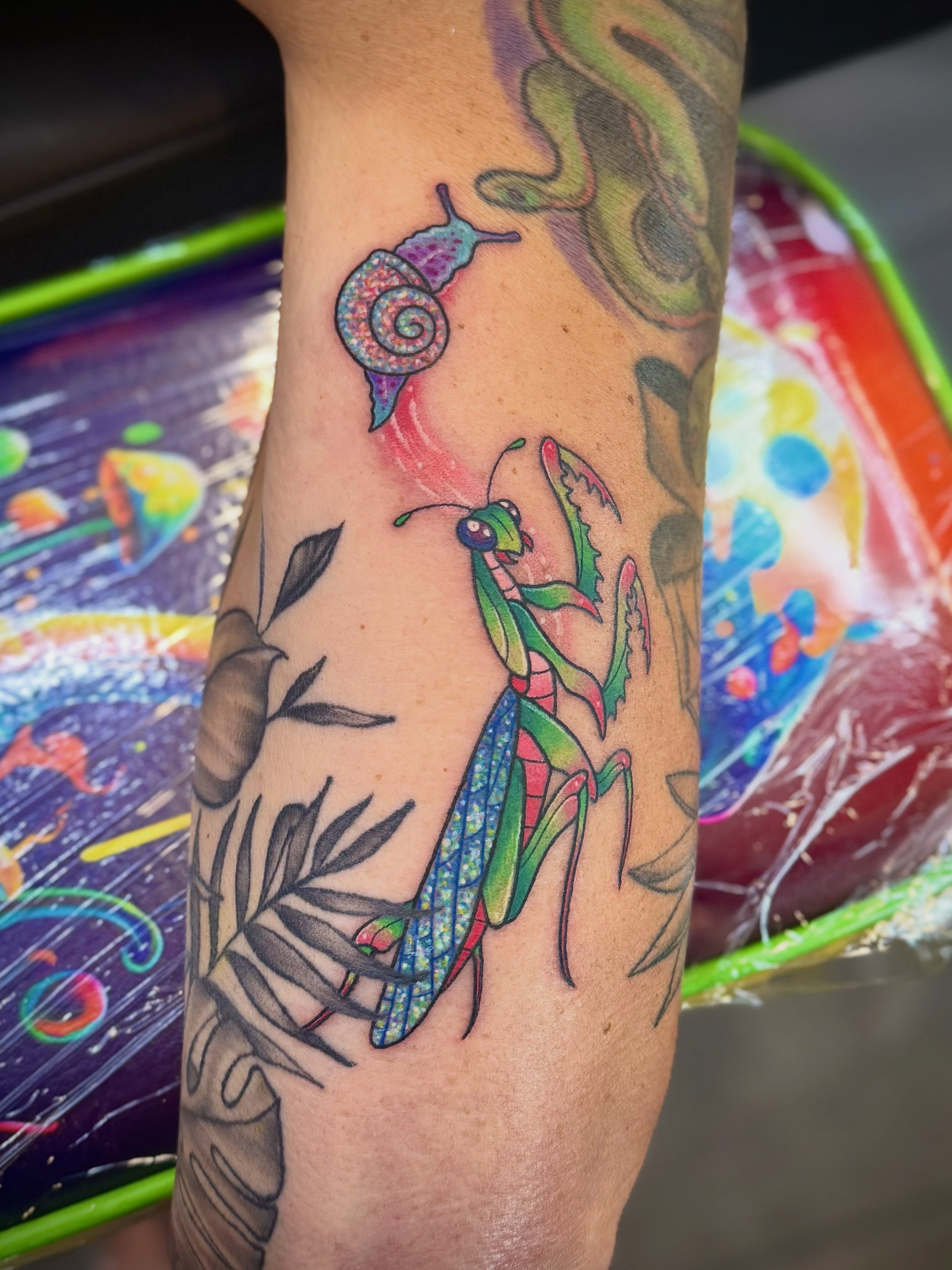 Praying mantis new school tattoo on the forearm by Ashley Kayser