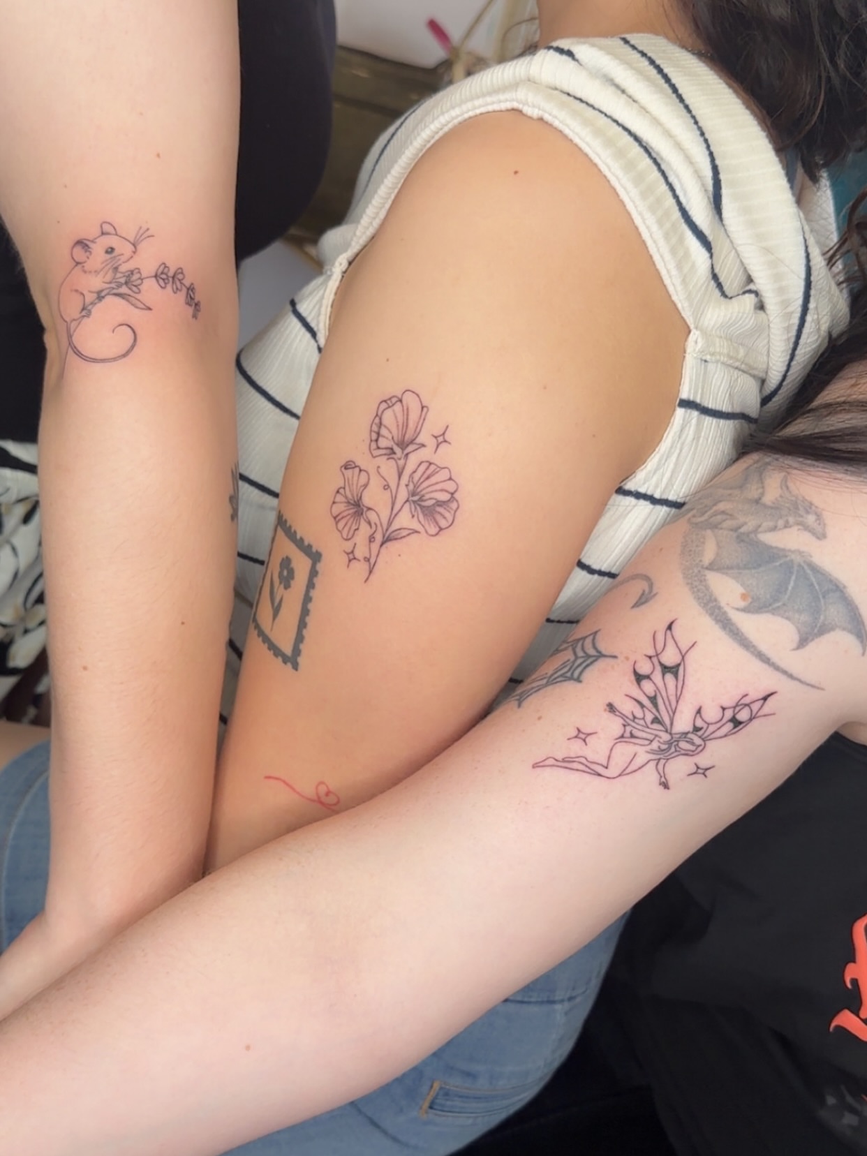 Flowers and mouse black and grey tattoo on the upper arm by NuNu