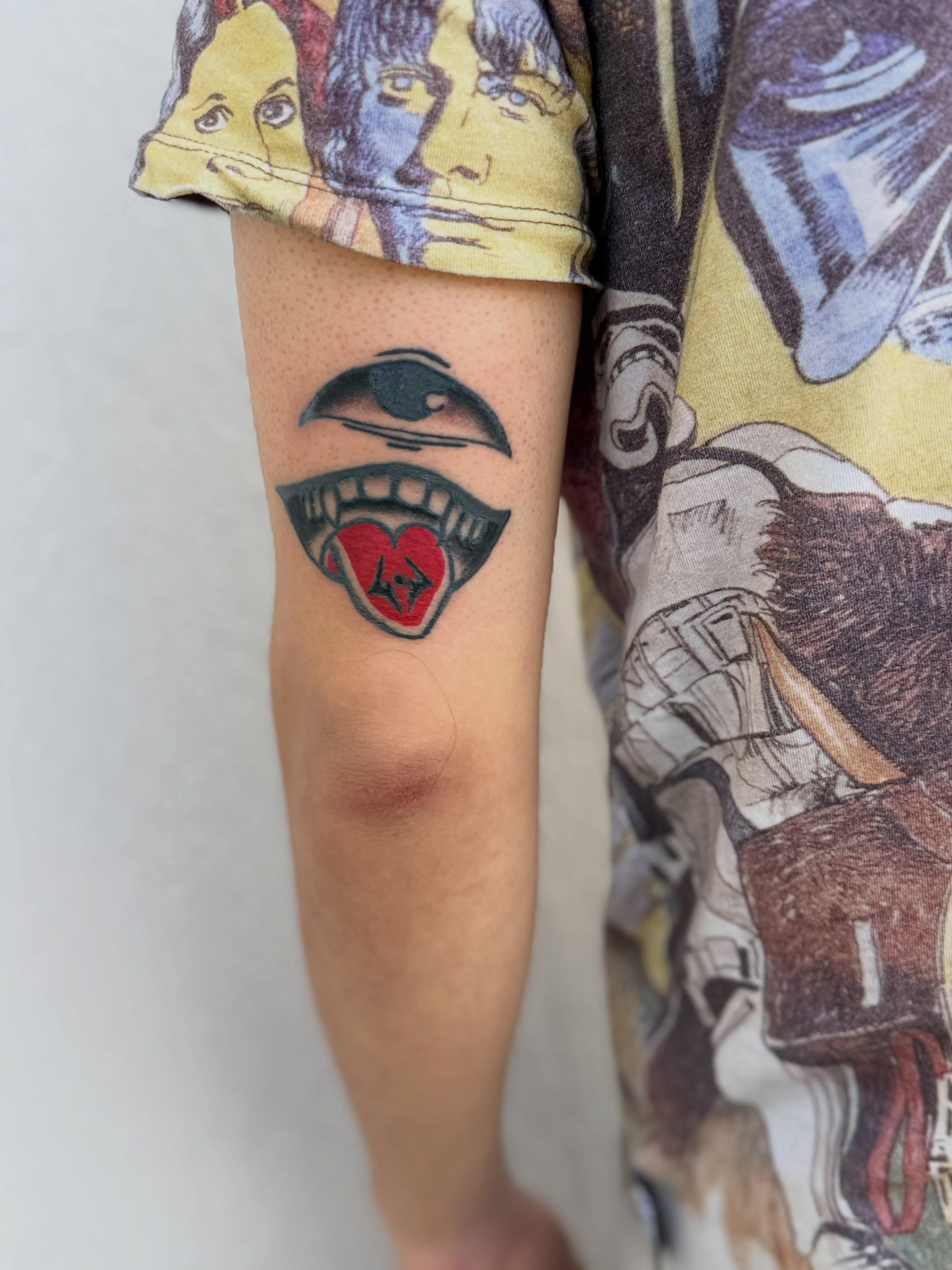 Lips with heart American traditional tattoo on the forearm by Camilo