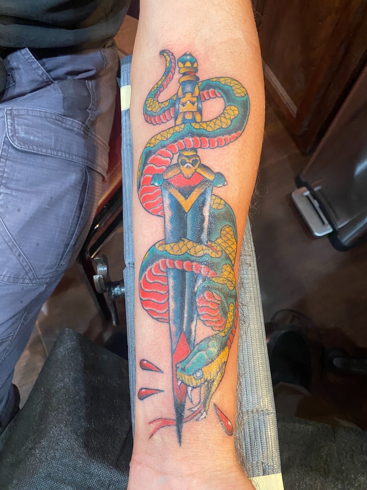 Snake and dagger American traditional tattoo on the forearm by Christopher Sanders