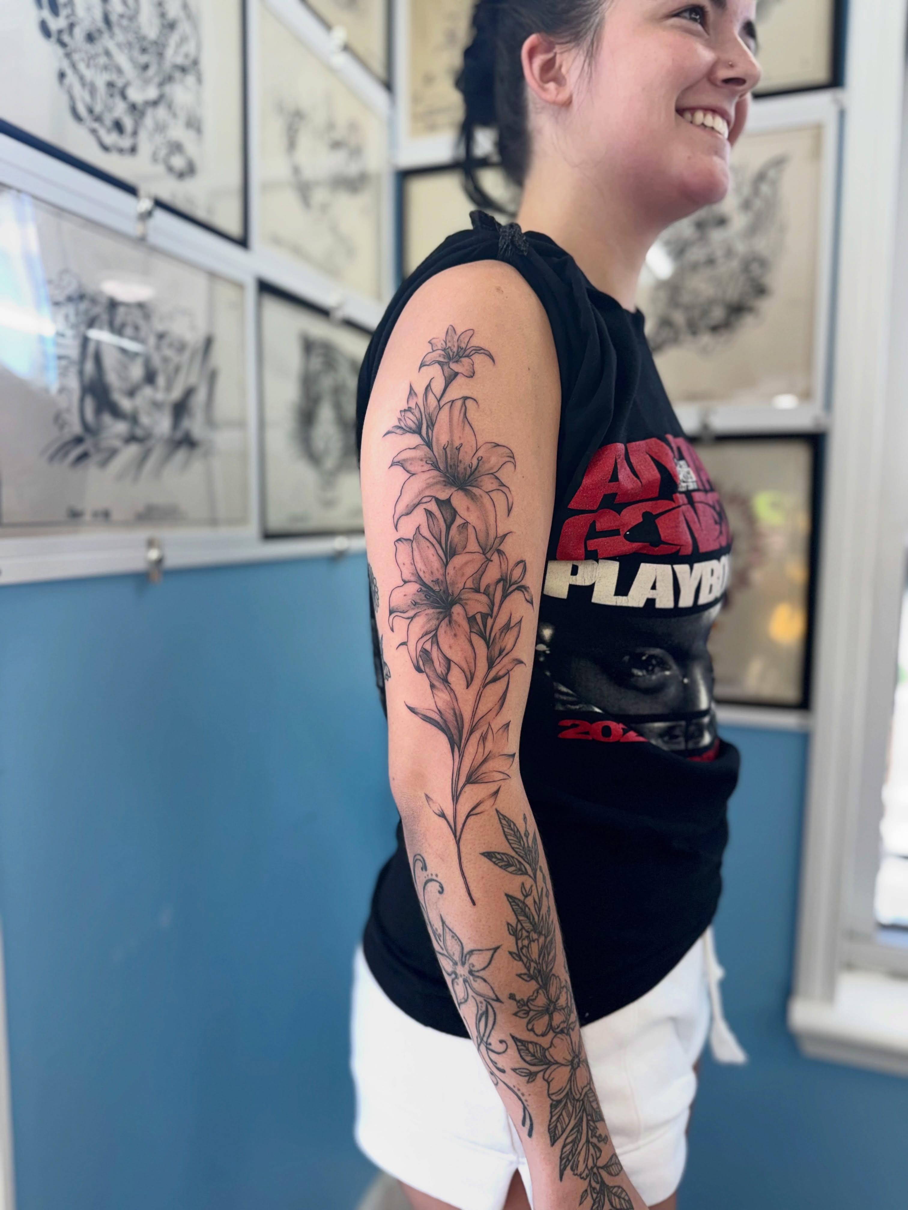 Lily black and grey tattoo on the forearm by Béle Benard