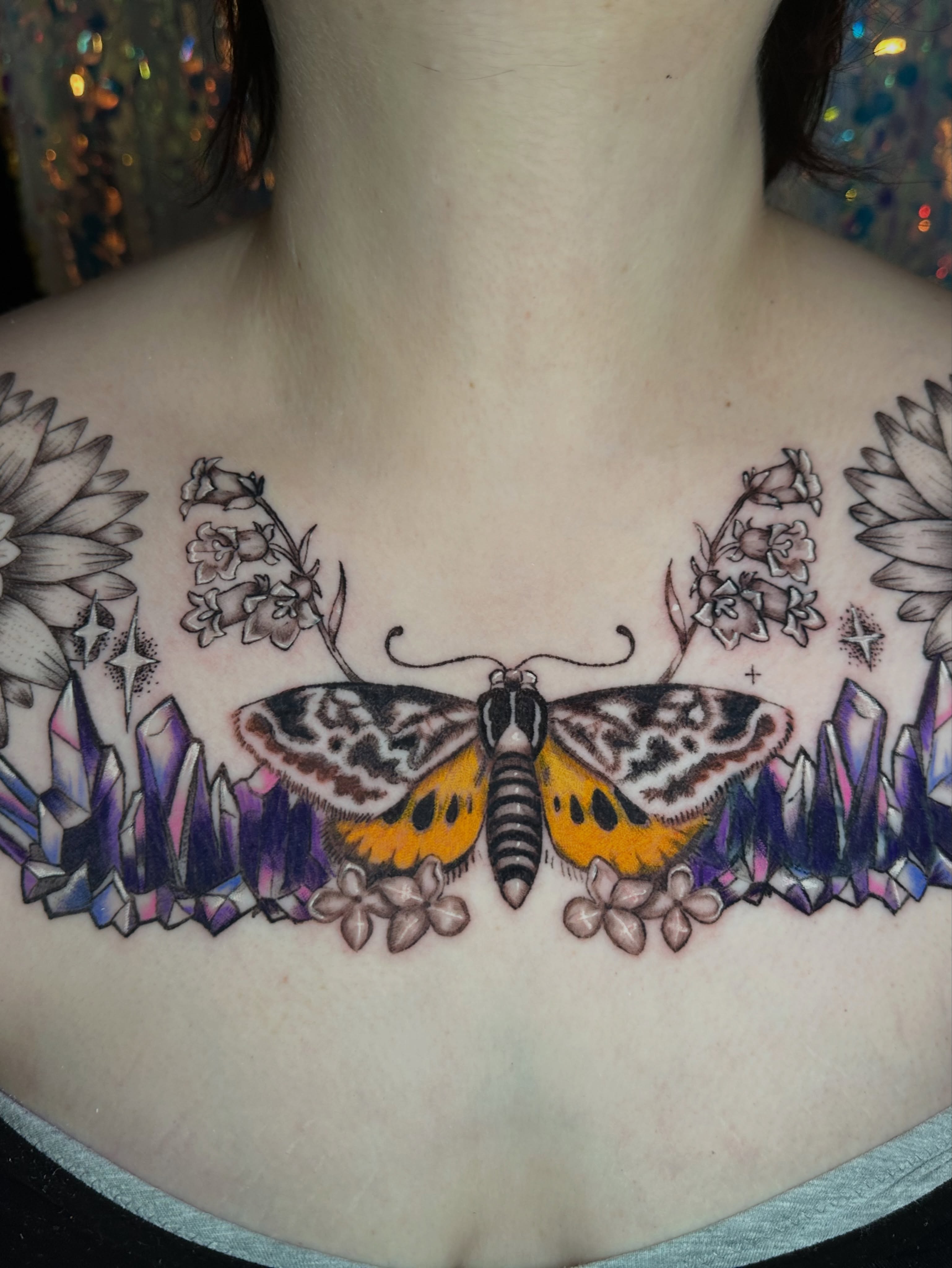 Butterfly and flowers realism tattoo on the chest by Sunny, Austin, Texas