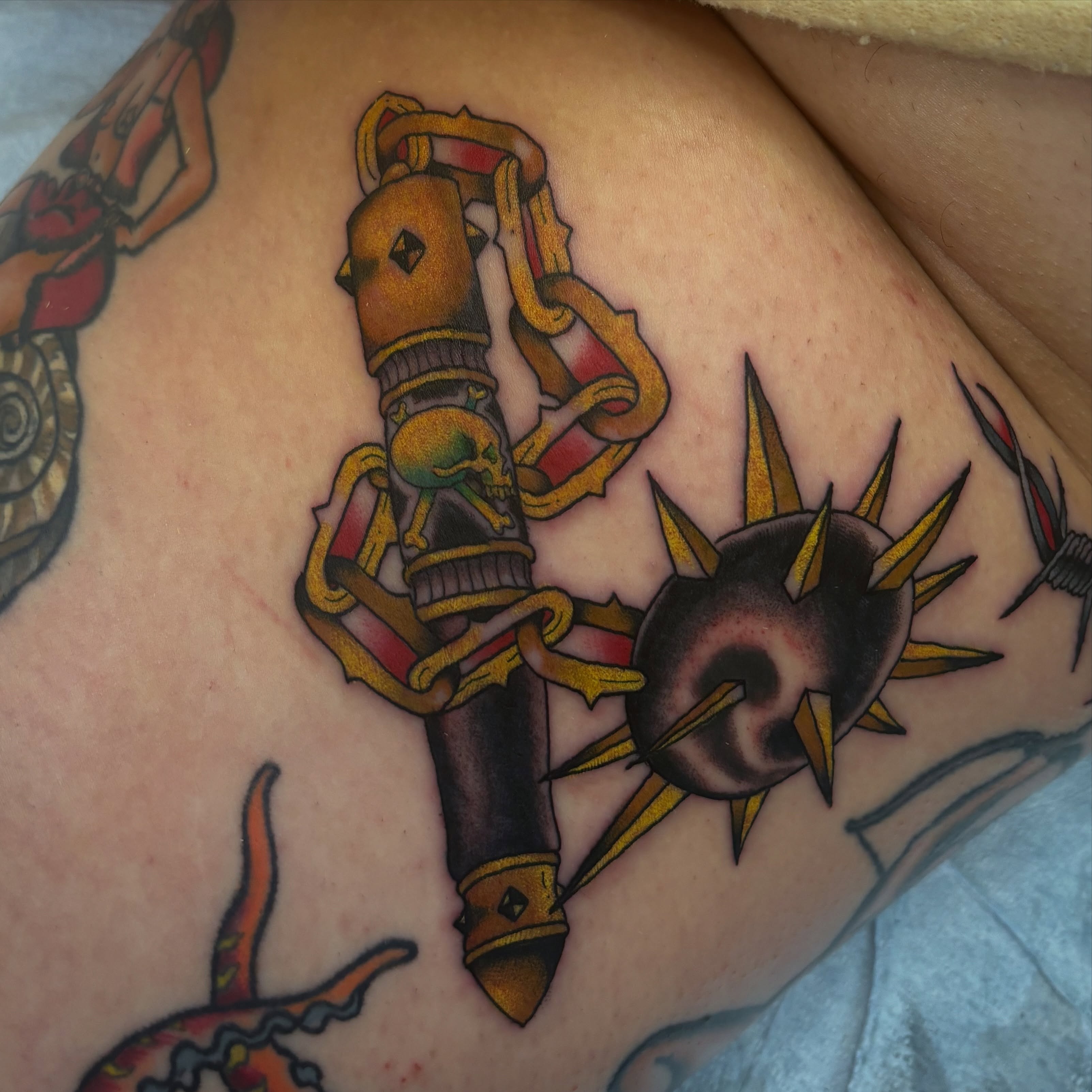 Gun and star American traditional tattoo on the thigh by Adam Bailey, Portland, Oregon
