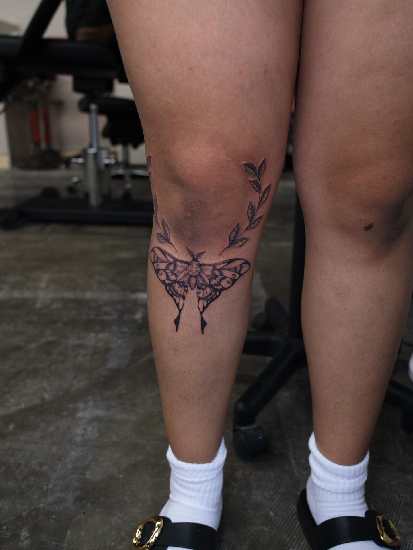 Moth black and grey tattoo on the calf by Kiana Hope